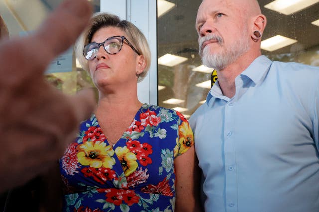 <p>Jessica Norton, with her husband, Gary, speaks with reporters outside of a Broward County School Board meeting</p>
