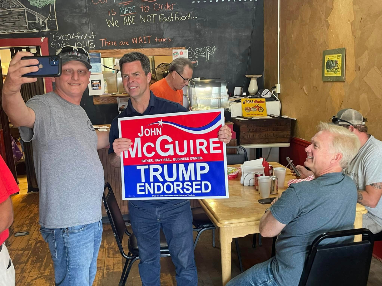 Trump-endorsed candidate John McGuire meets voters in June 2024 at a campaign stop. His primary race against Good was closer than many had expected