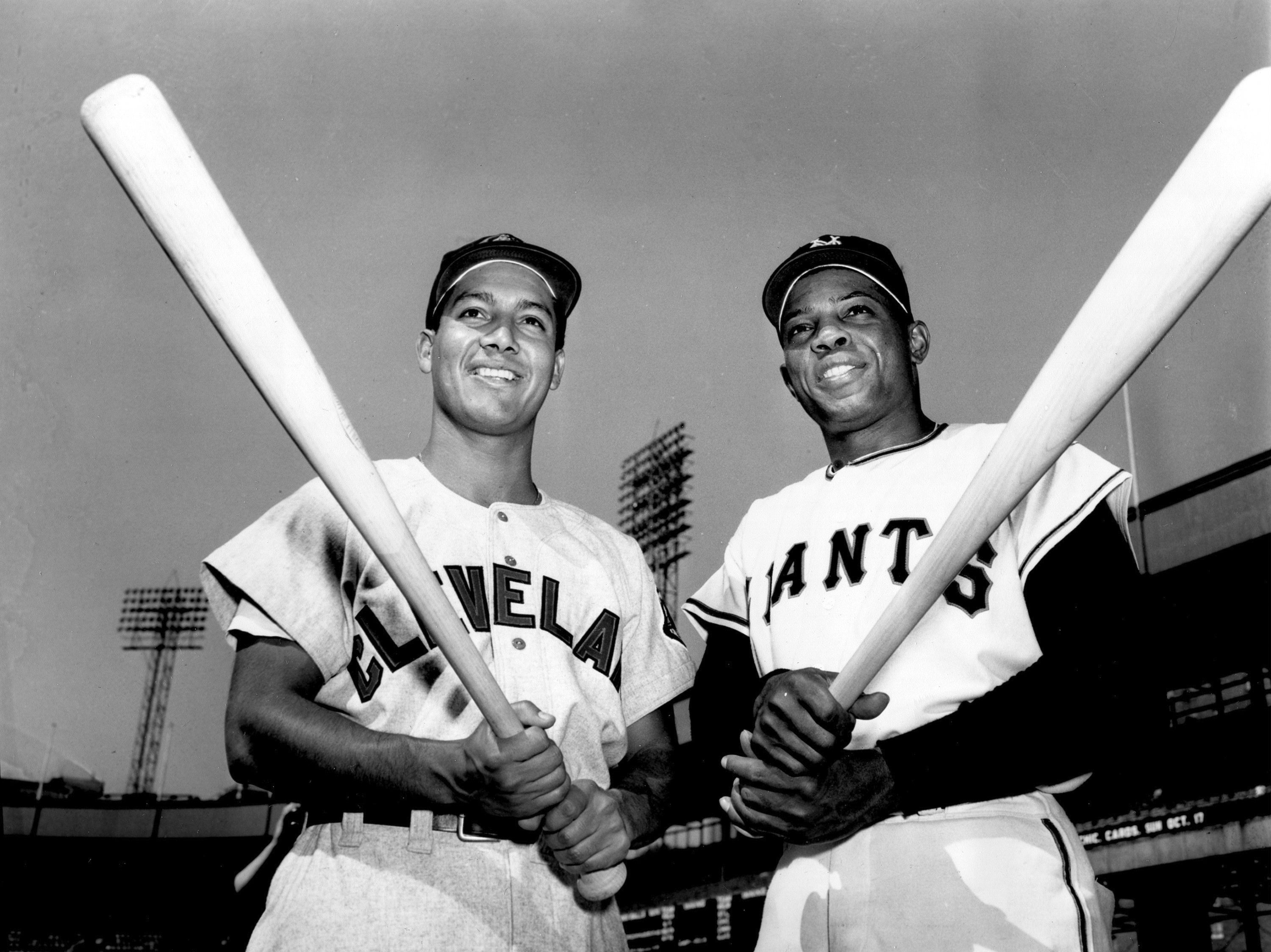 Batting champions Bobby Avila, left, of the Cleveland Indians, and Willie Mays, of the New York Giants, pose with their bats at the Polo Grounds in New York on Sept 28, 1954