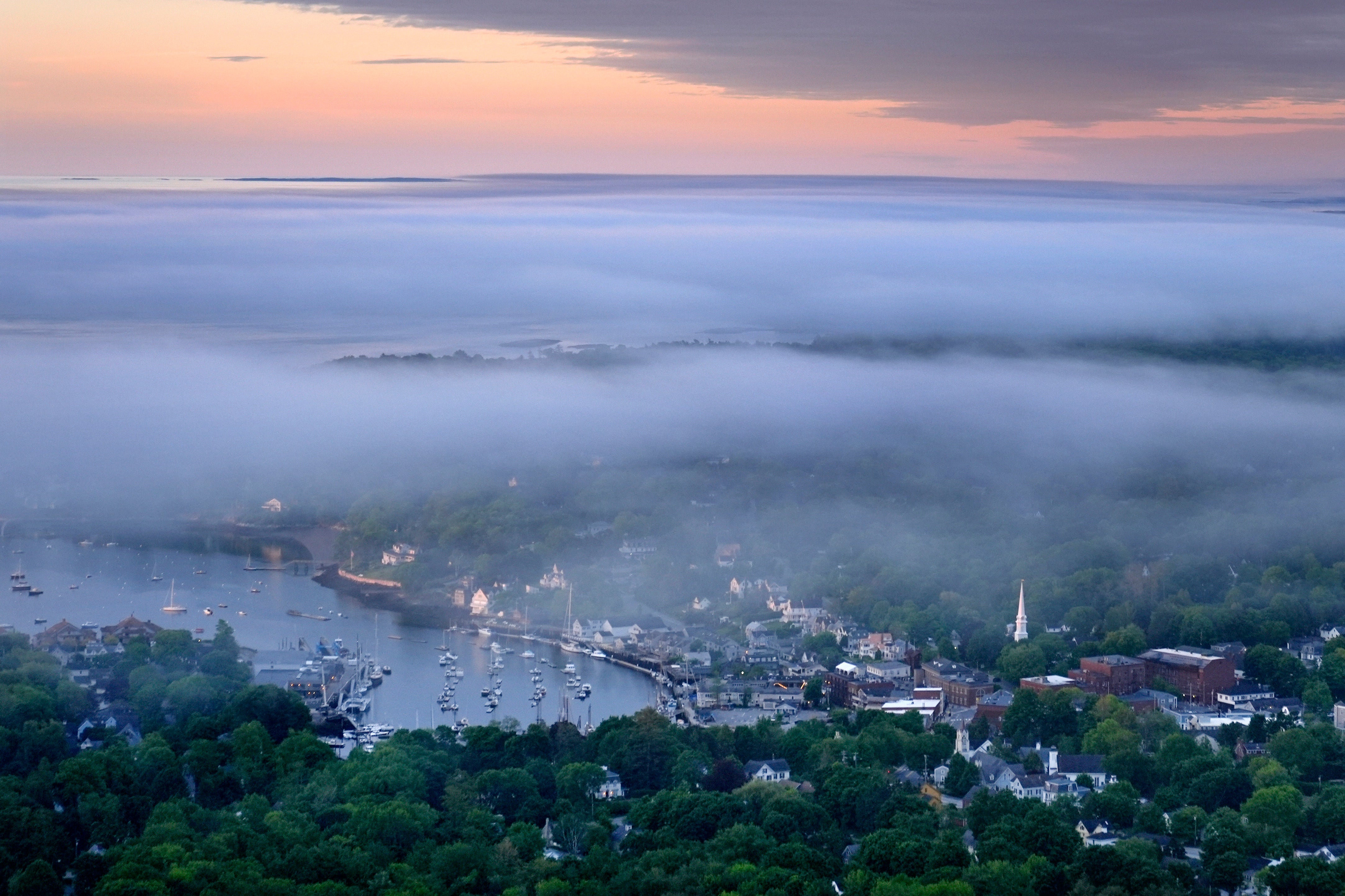 Layers of fog drift over in Camden, Maine, Tuesday, June 4, 2024