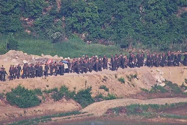 <p>In this undated photo provided on Tuesday, June 18, 2024, by South Korea Defense Ministry, North Korean soldiers work at an undisclosed location near the border area, as seen from a South Korean guard area</p>