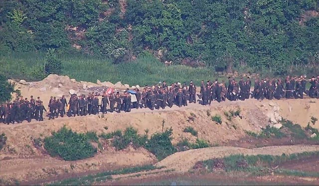 <p>In this undated photo provided on Tuesday, June 18, 2024, by South Korea Defense Ministry, North Korean soldiers work at an undisclosed location near the border area, as seen from a South Korean guard area</p>