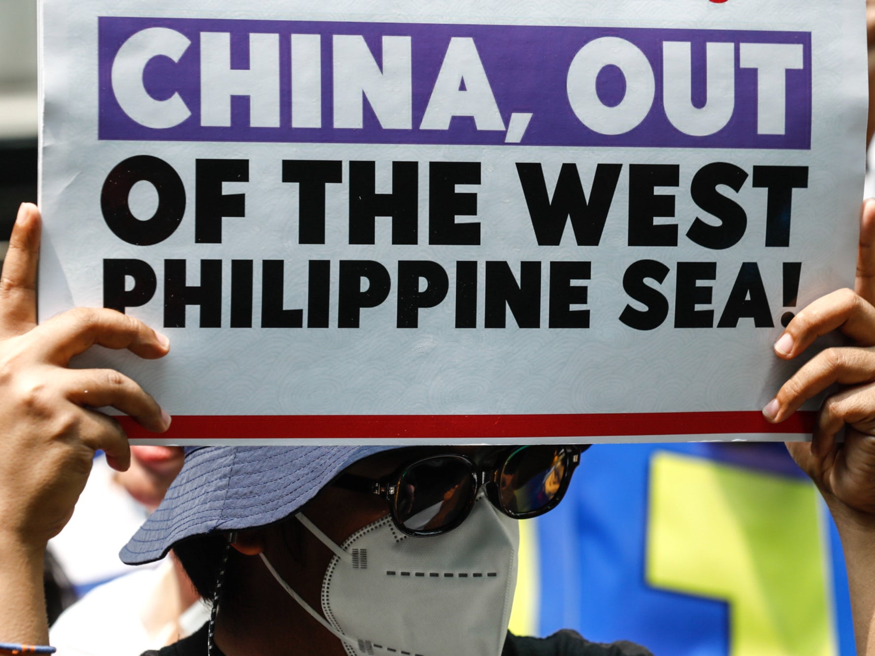 A protester holds a sign criticising China’s actions against Philippine vessels in disputed waters of the South China Sea during a rally outside China’s consular office in Makati City, Metro Manila, Philippines, on 11 June 2024