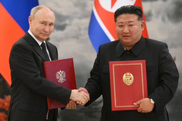 <p>Russia’s president Vladimir Putin and North Korea’s leader Kim Jong-un shake hands after signing a bilateral agreement</p>