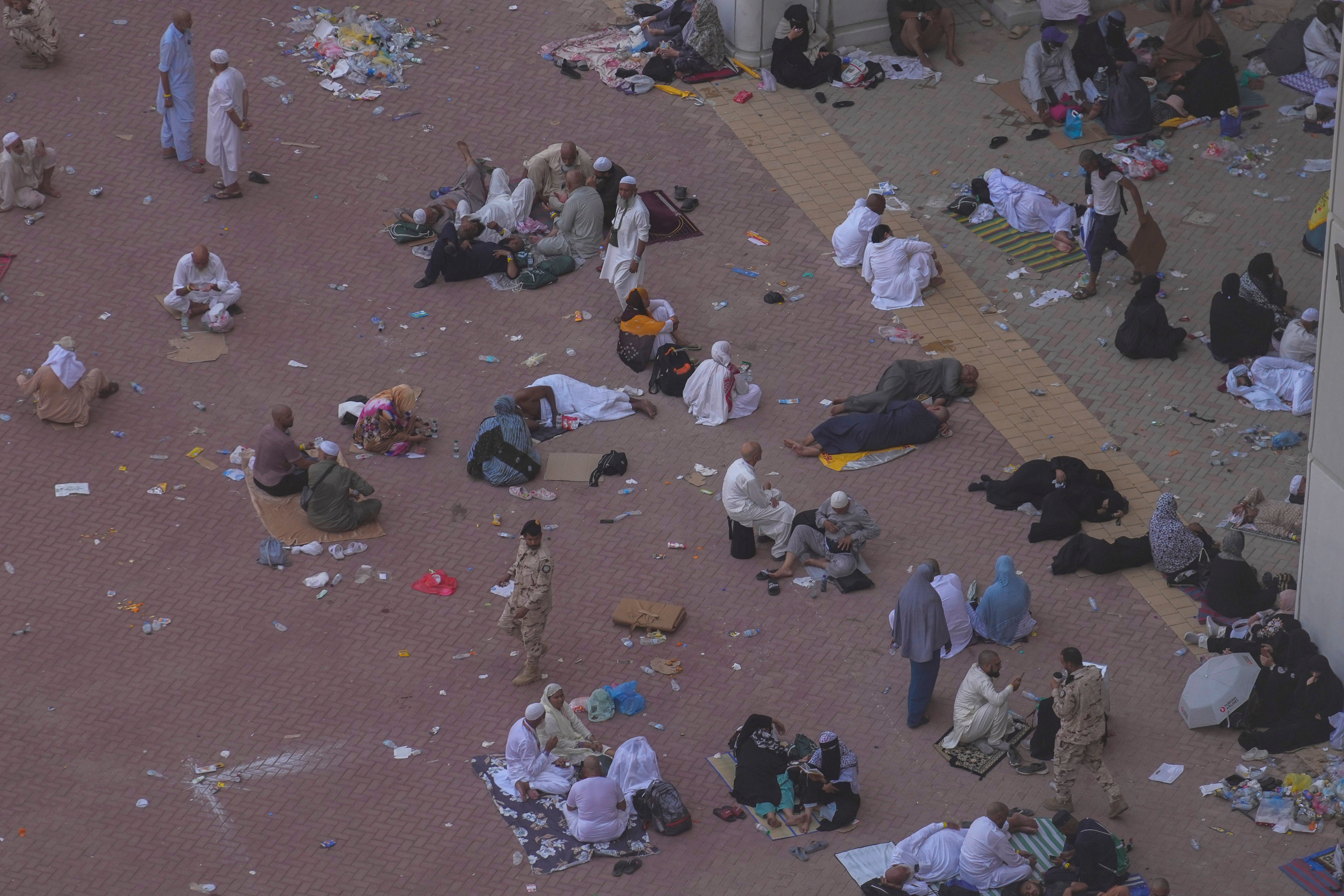 People rest after casting stones at pillars in the symbolic stoning of the devil, the last rite of Hajj
