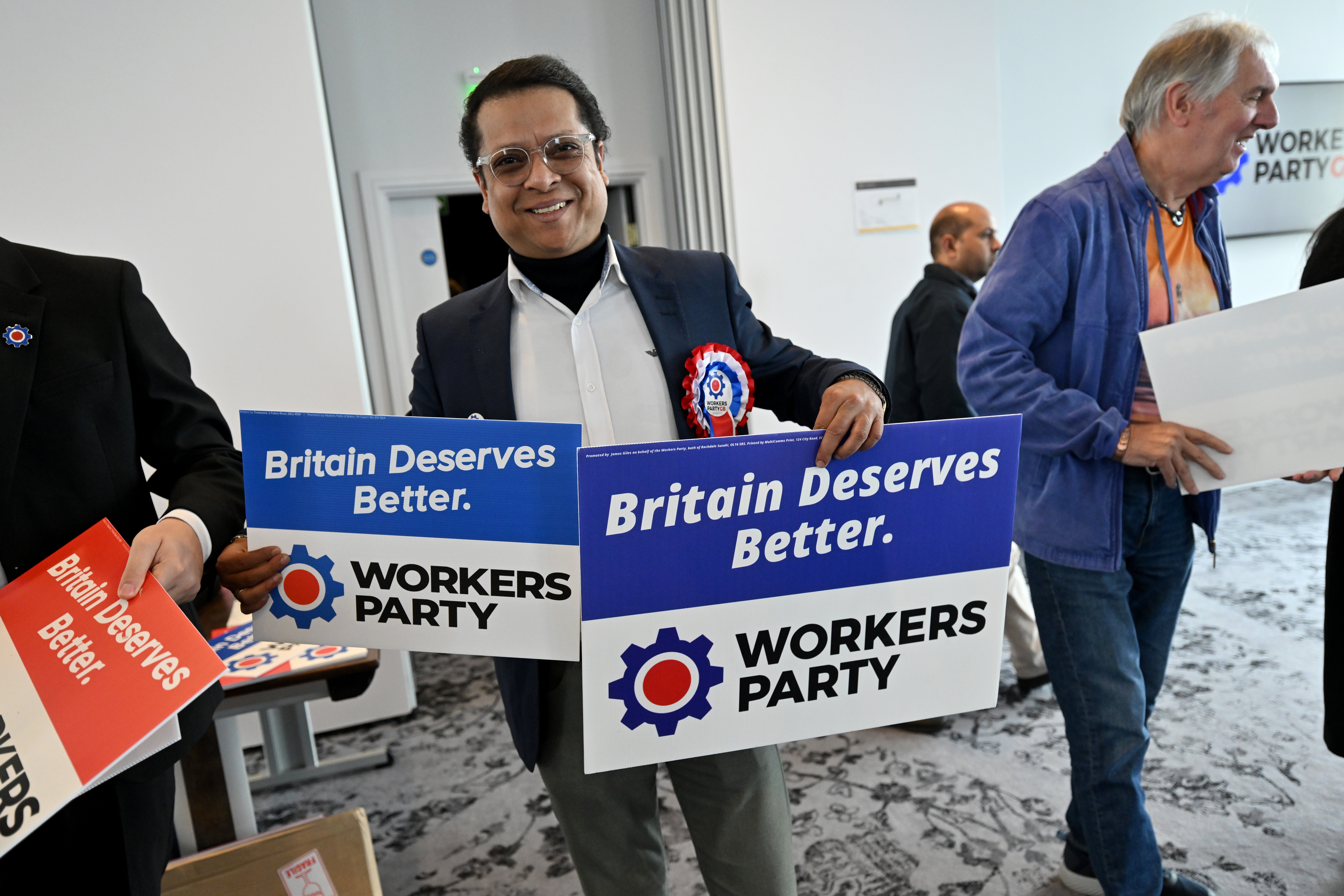 A supporter hands-out placards during the Workers Party of Britain manifesto launch