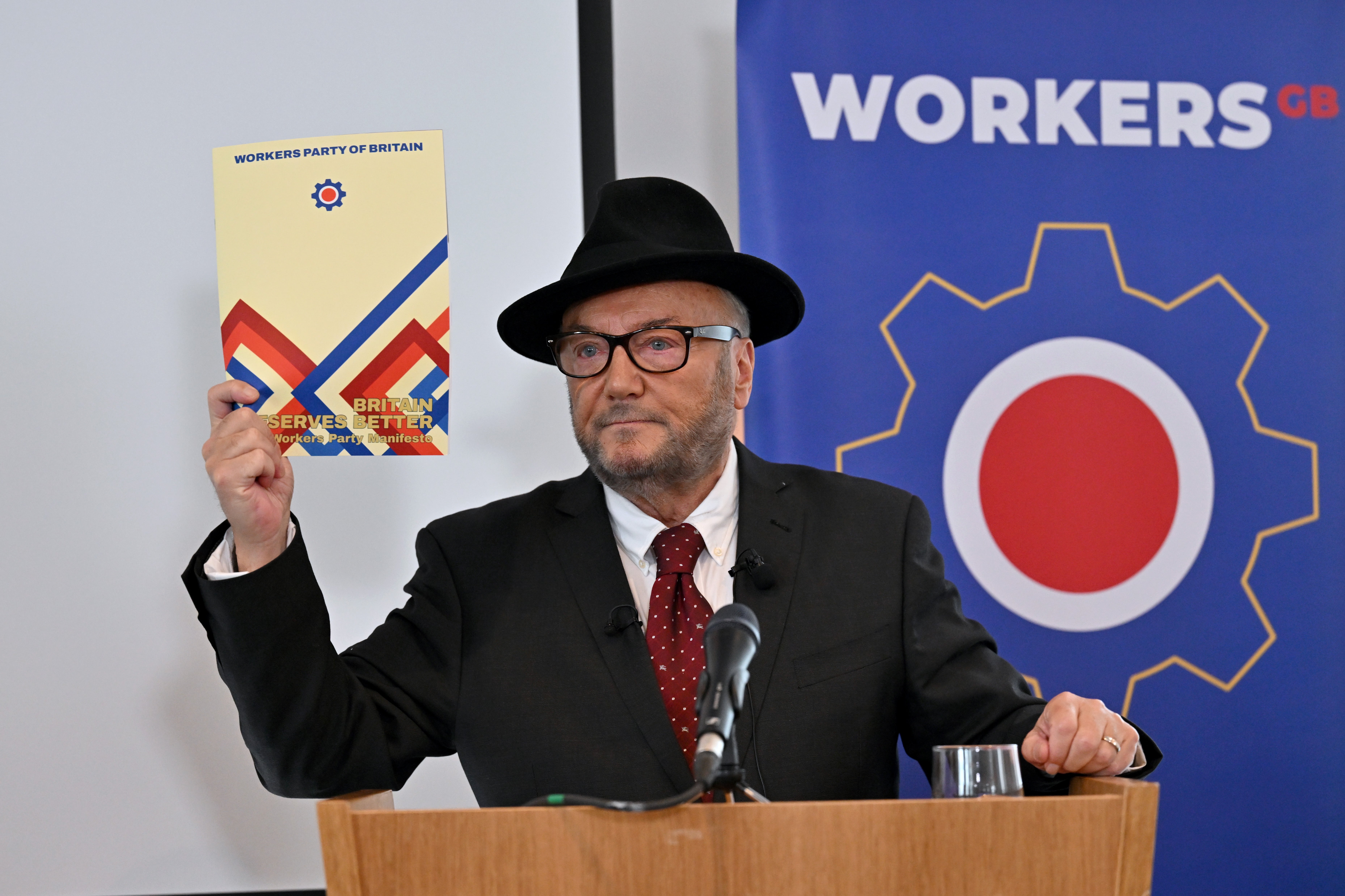 Leader of the Workers Party of Britain George Galloway holds a copy of the manifesto during his party’s manifesto launch on Wednesday