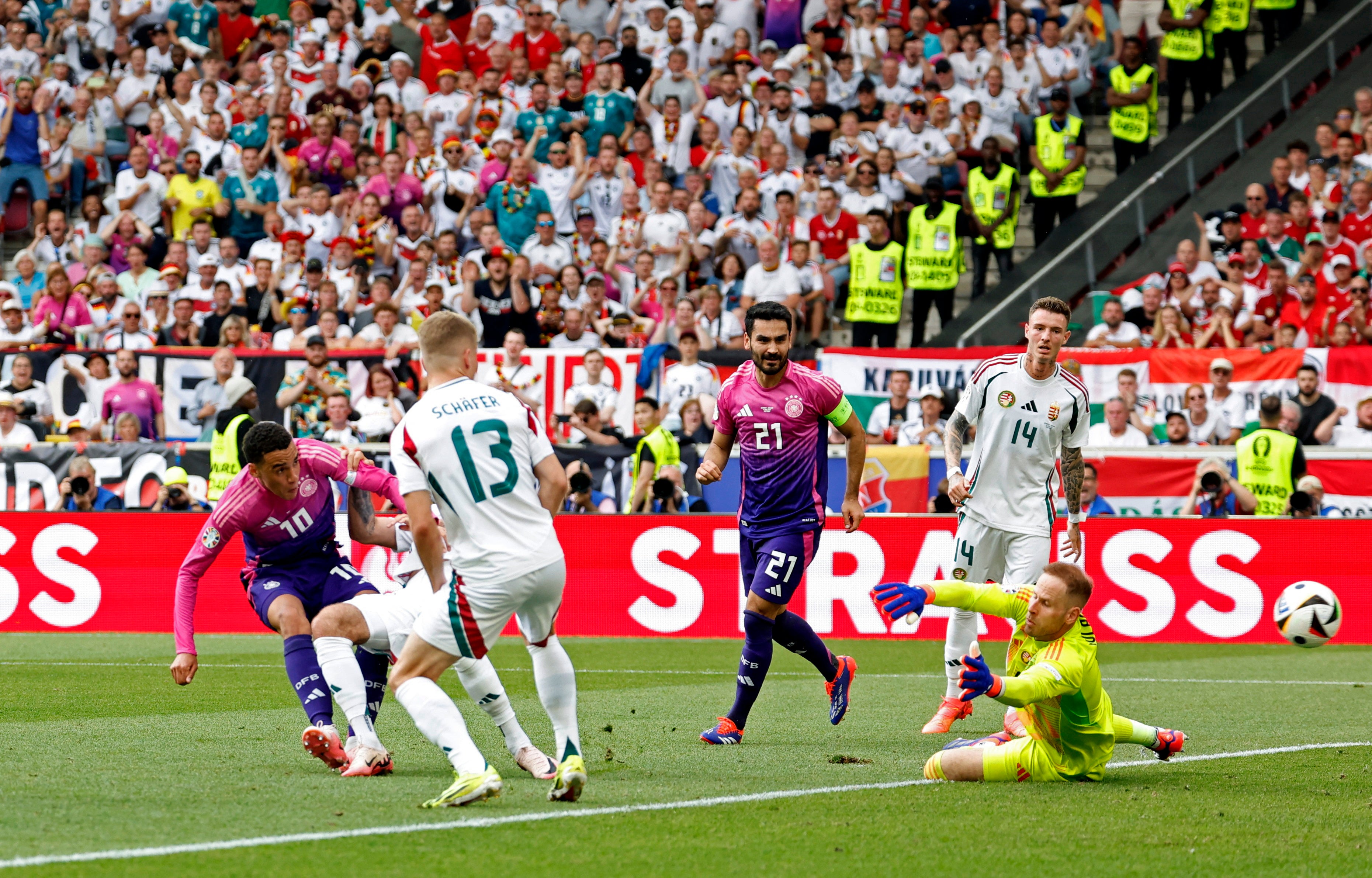 Jamal Musiala, left, fires Germany in front