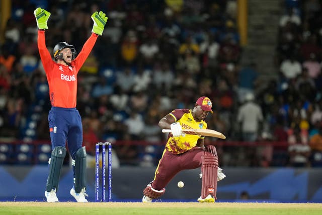 England’s captain Jos Buttler, left, appeals for the wicket of West Indies’ captain Rovman Powell (Ramon Espinosa/AP)
