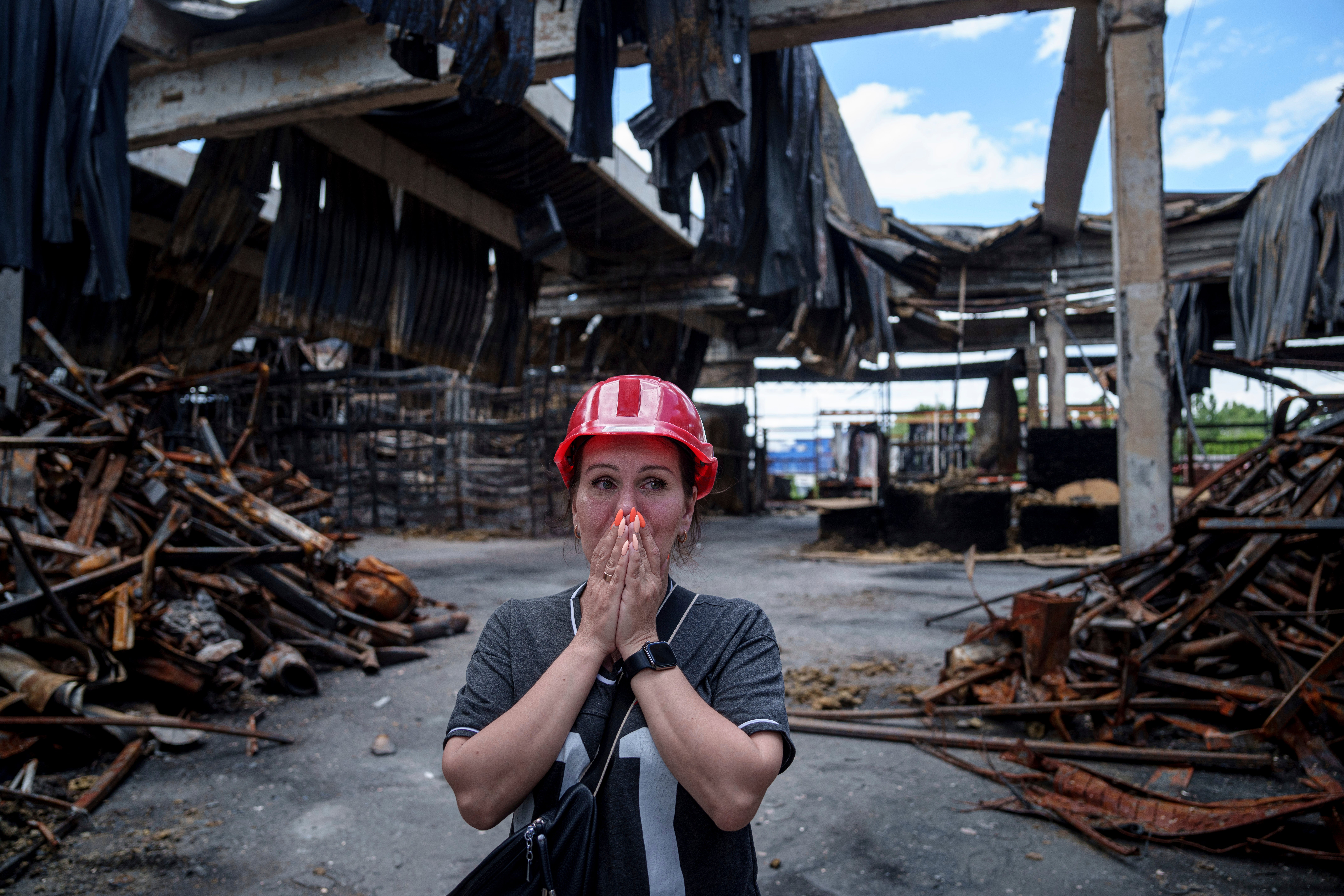 Nina Korsunova gets emotional as she walks inside the destroyed Epicenter shopping complex in Kharkiv, Ukraine