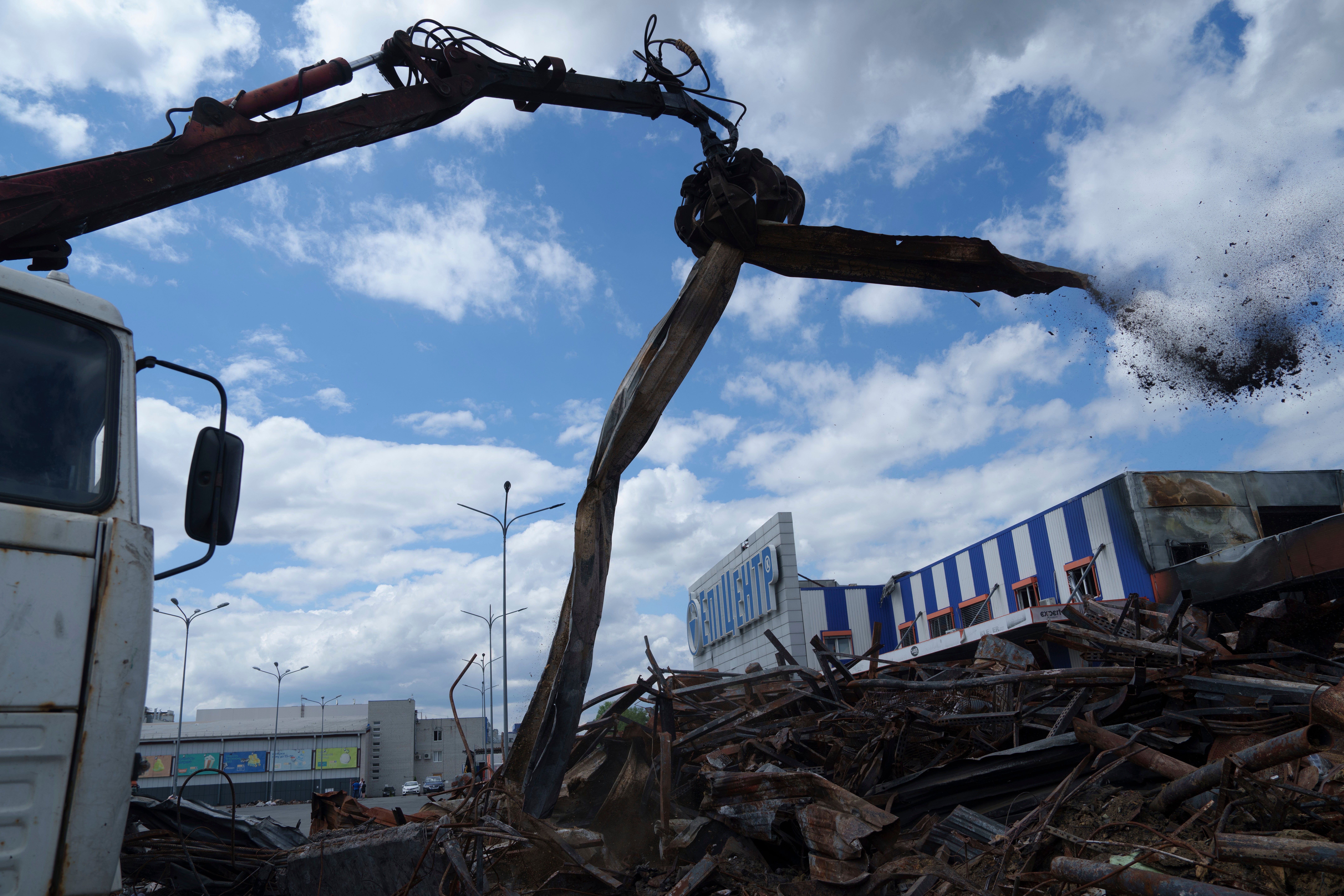An excavator clears the rubble from the Epicenter shopping complex in Kharkiv, Ukraine, Thursday, June 6, 2024