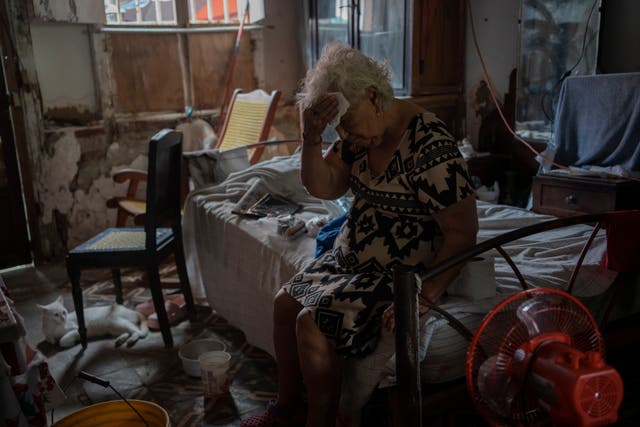 <p>Margarita Salazar, 82, wipes the sweat off with a tissue inside her home amid high heat in Veracruz, Mexico</p>