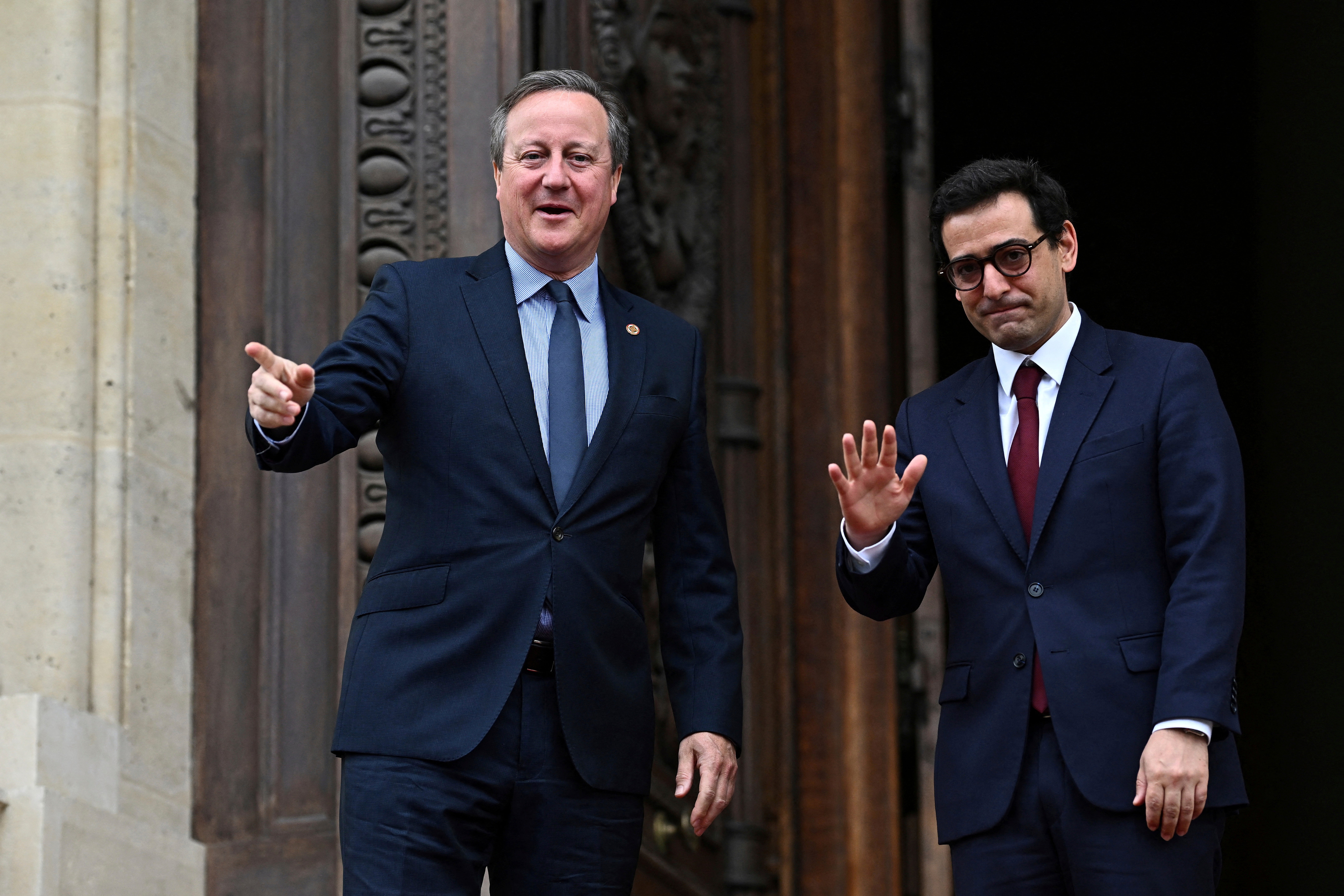 French Foreign Minister Stephane Sejourne, right, welcomes Britain's Foreign Secretary David Cameron as he arrives to attend the African Vaccine Manufacturing Accelerator