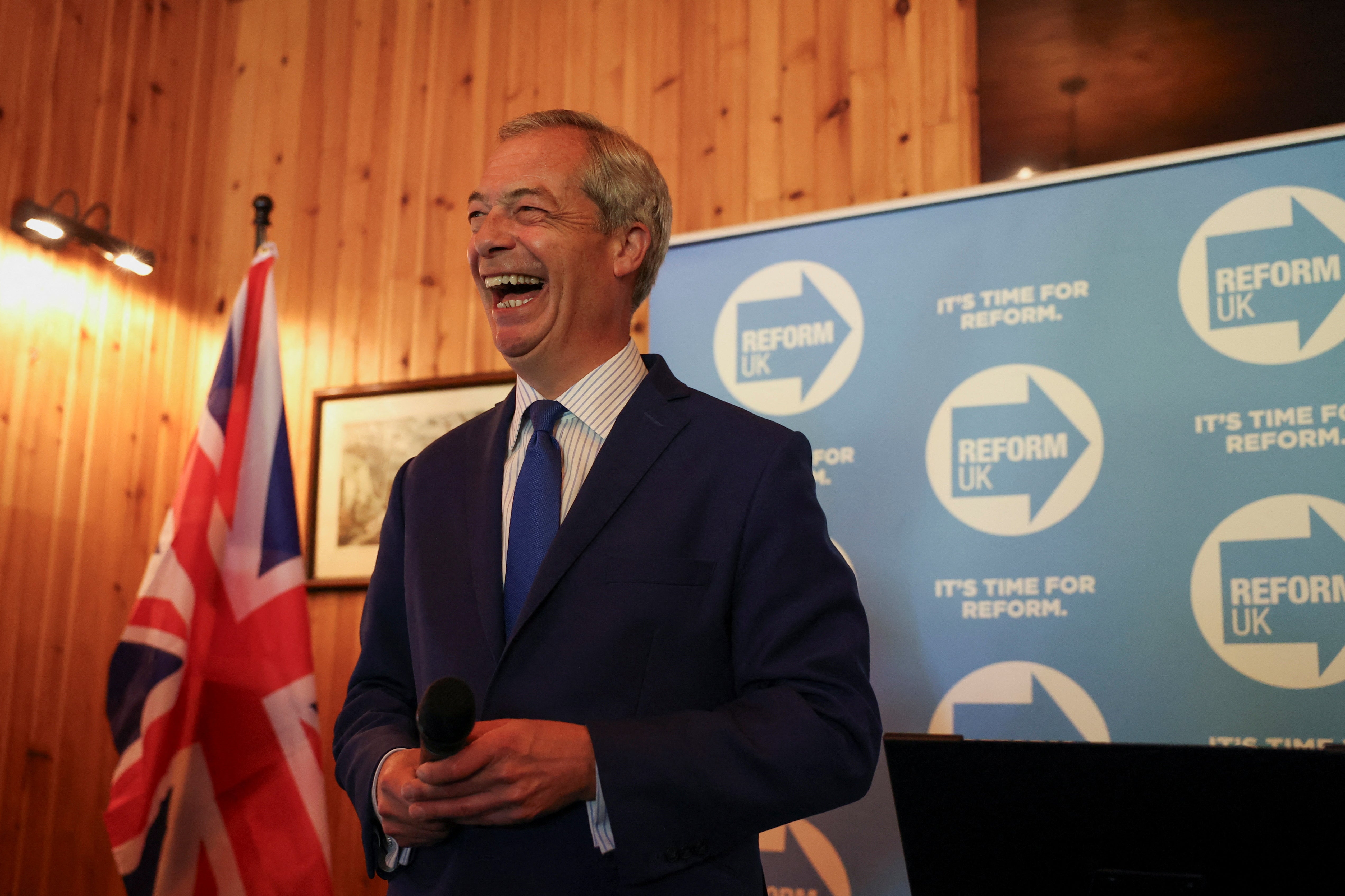 Britain's Reform UK Party Leader Nigel Farage reacts during a campaign event in Frodsham, Cheshire