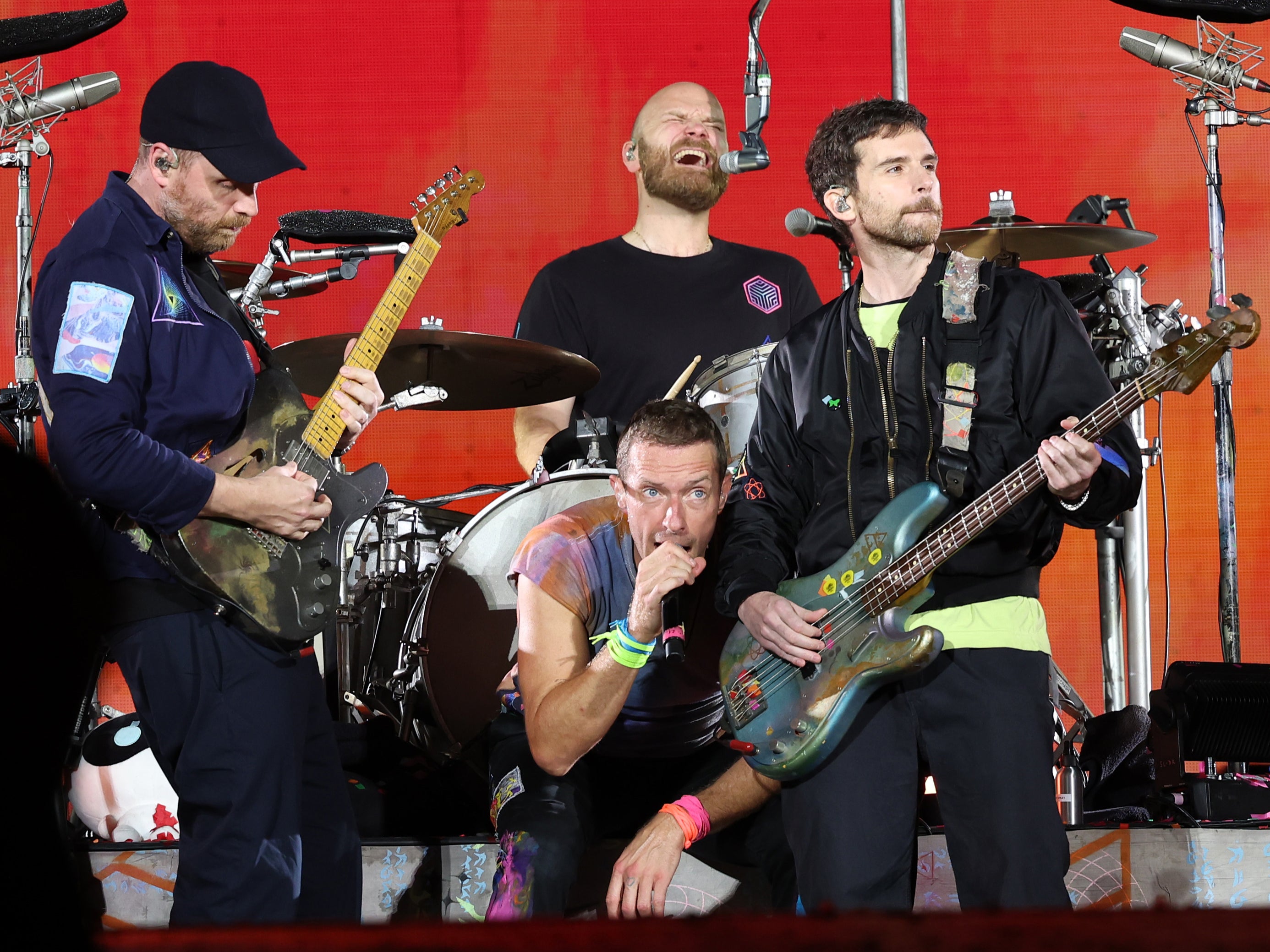 Jonny Buckland, Chris Martin, Will Champion and Guy Berryman of Coldplay performing at Rose Bowl Stadium on September 30, 2023