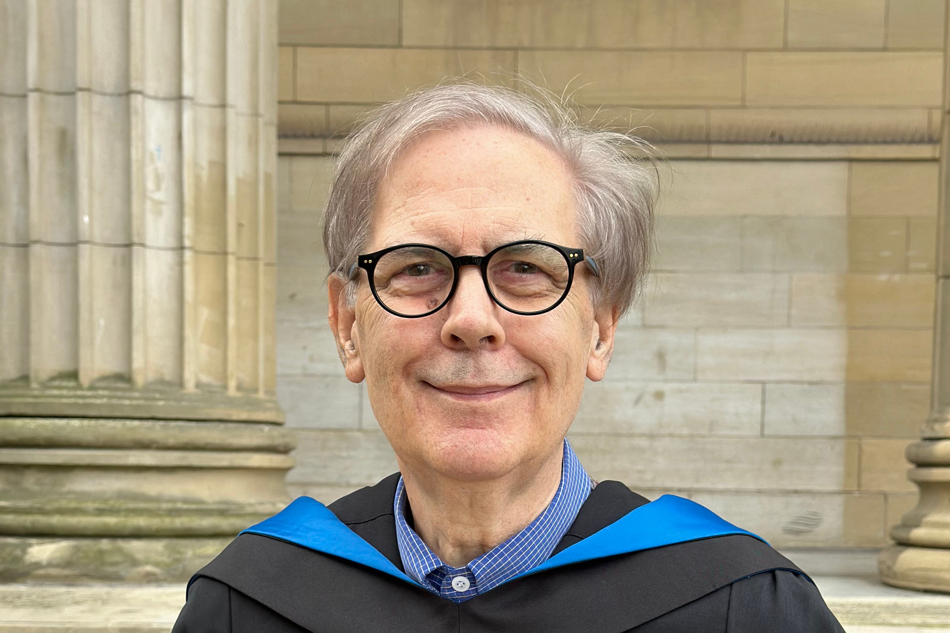 Michael Harrigan, 75, in his gown ahead of his graduation (University of Dundee/PA)