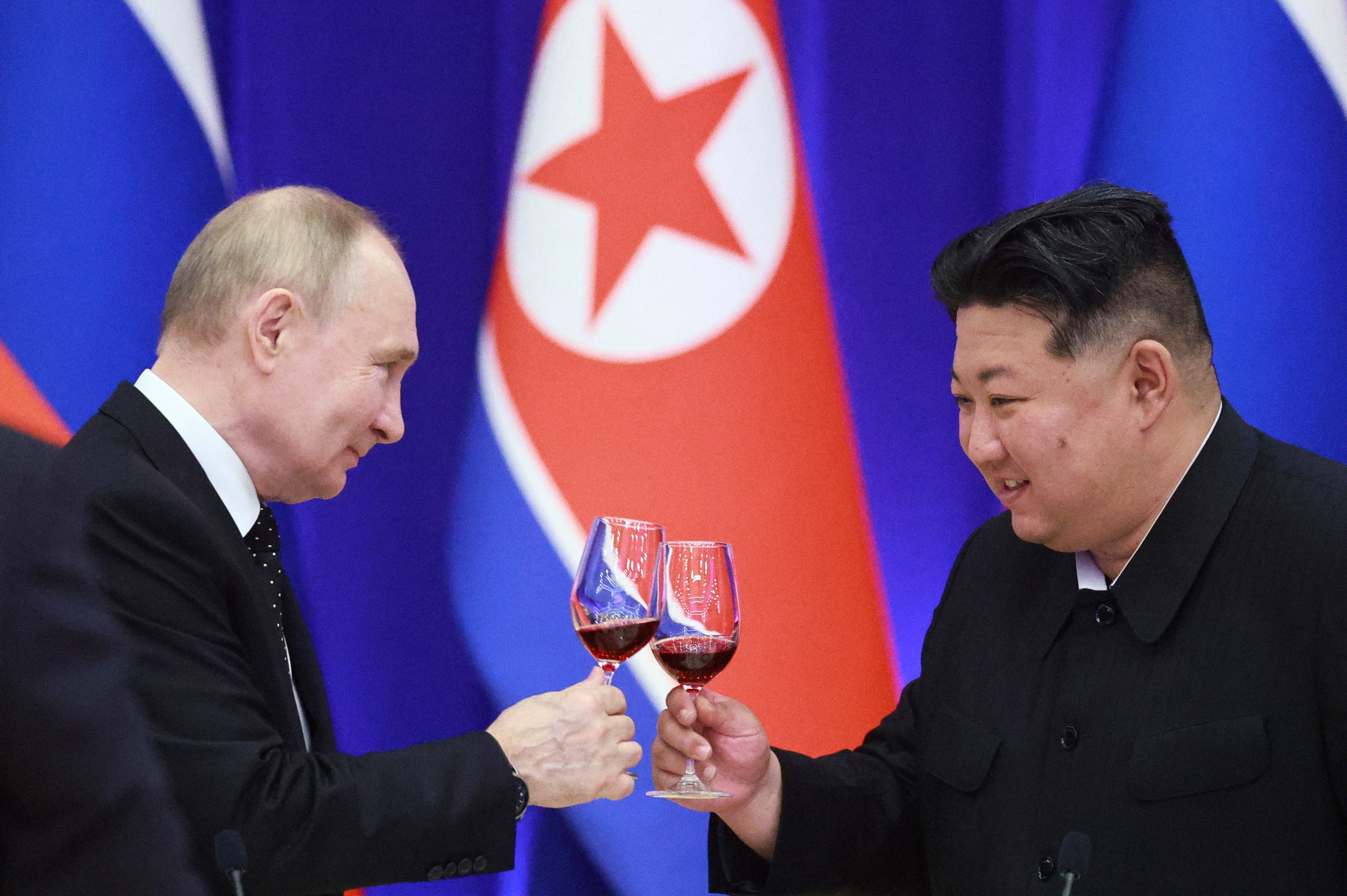 Vladimir Putin and leader Kim Jong-un toast during a reception at the Mongnangwan Reception House in Pyongyang on 19 June 2024
