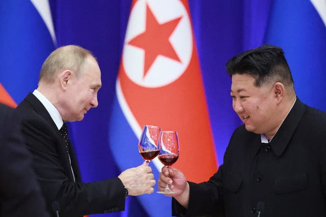 <p>Vladimir Putin and leader Kim Jong-un toast during a reception at the Mongnangwan Reception House in Pyongyang on 19 June 2024</p>