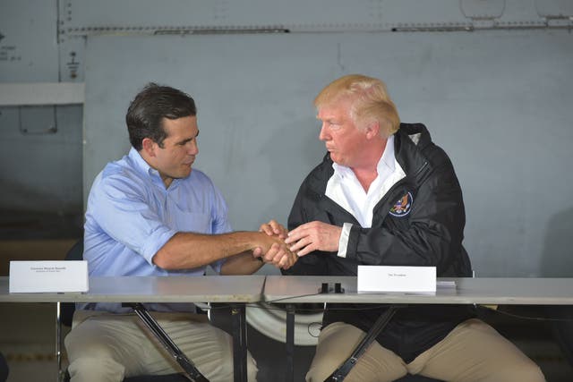 <p>US President Donald Trump attends a meeting with Governor Ricardo Rossello (L)and other officials in Carolina, Puerto Rico, on October 3, 2017. </p>