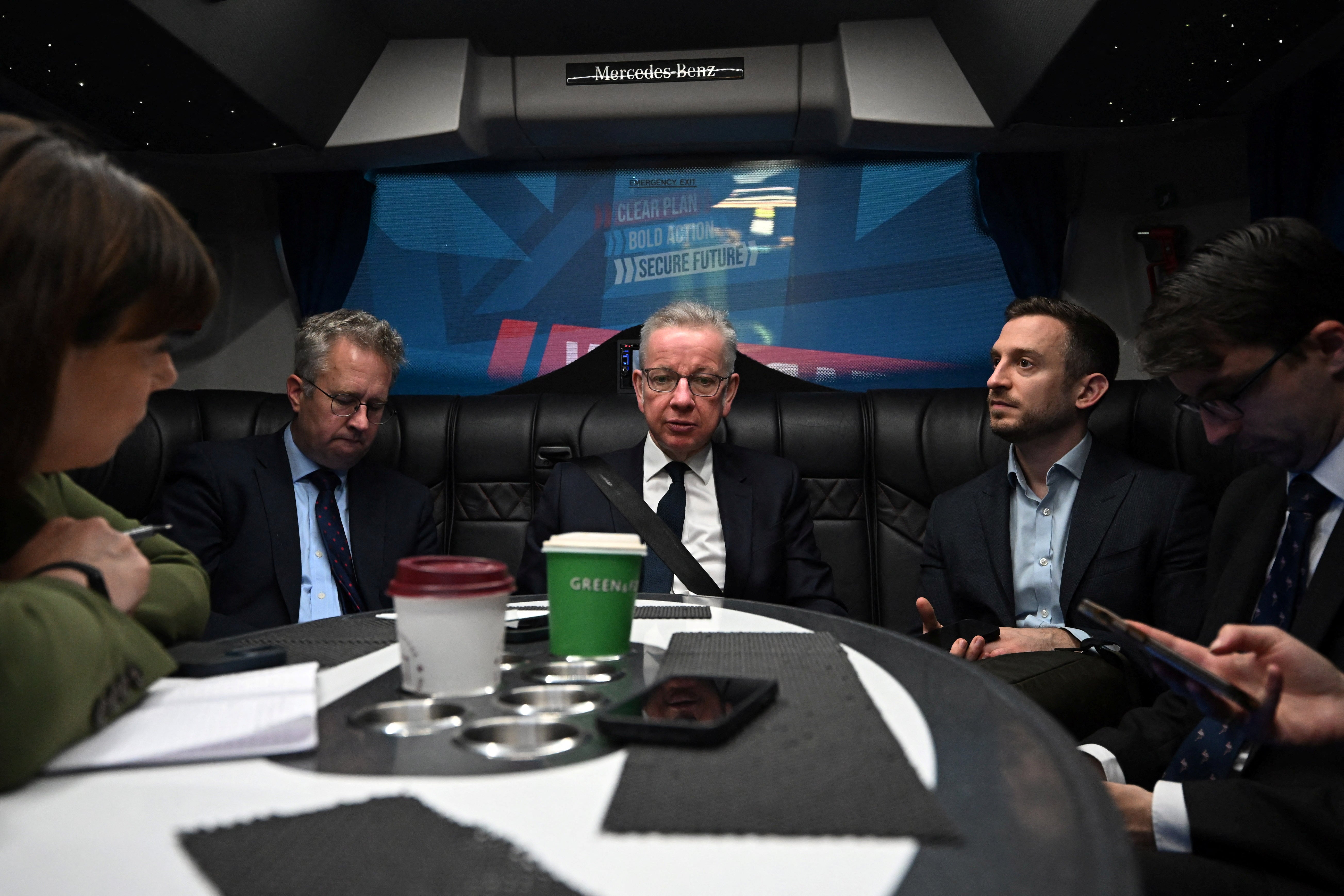 Michael Gove at the back of the battle bus as journalists ready their questions