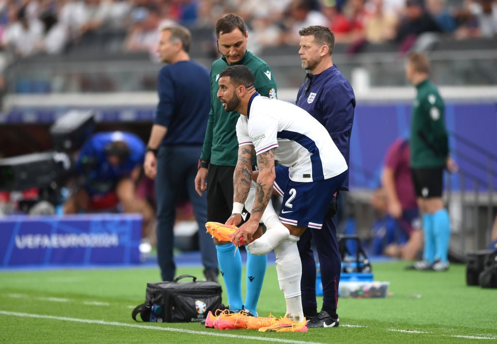Kyle Walker changes his boots after slipping early on against Denmark
