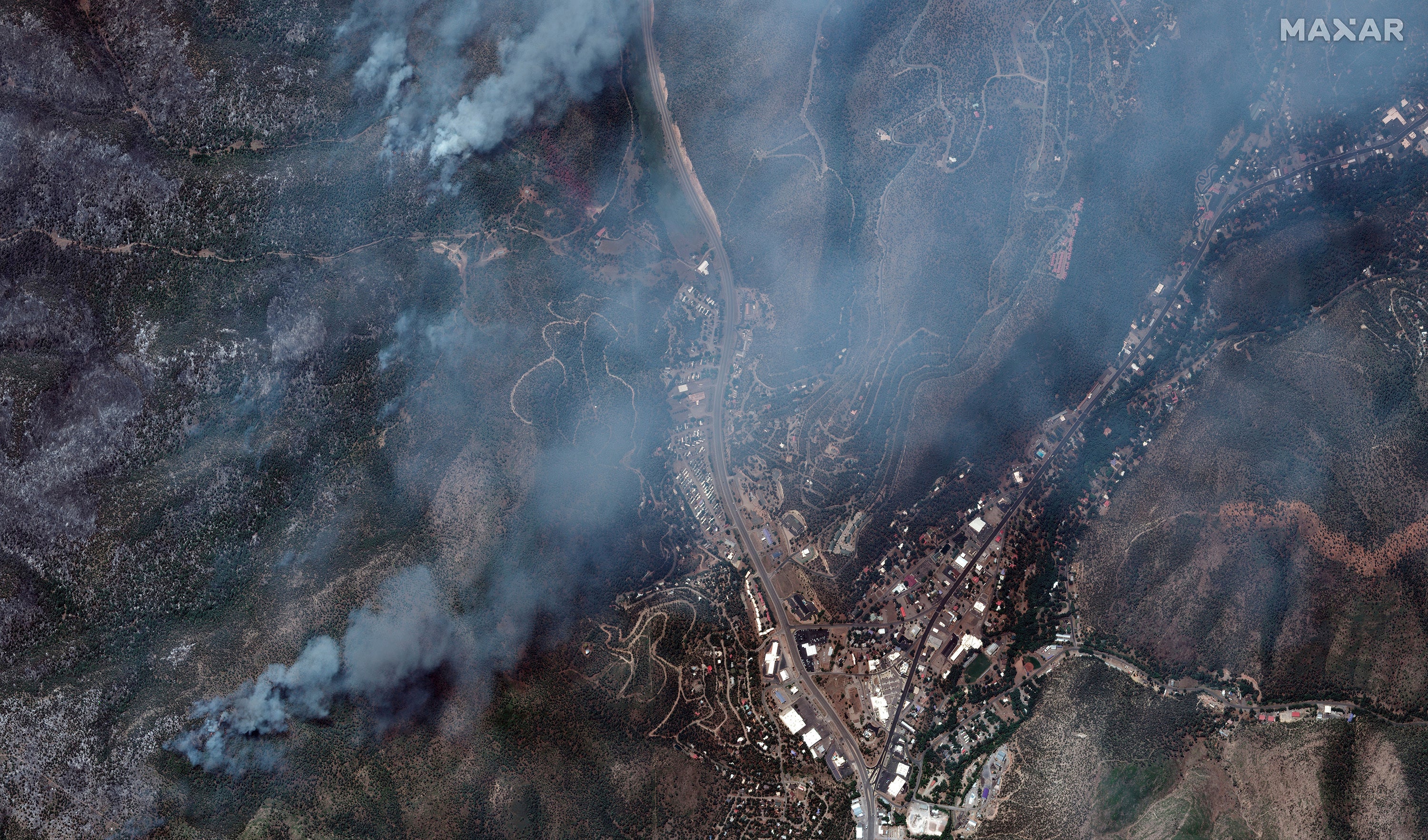Satellite imagery shows the wildfires burning through southern New Mexico. At least two people are dead as the South Fork and Salt fires rage on