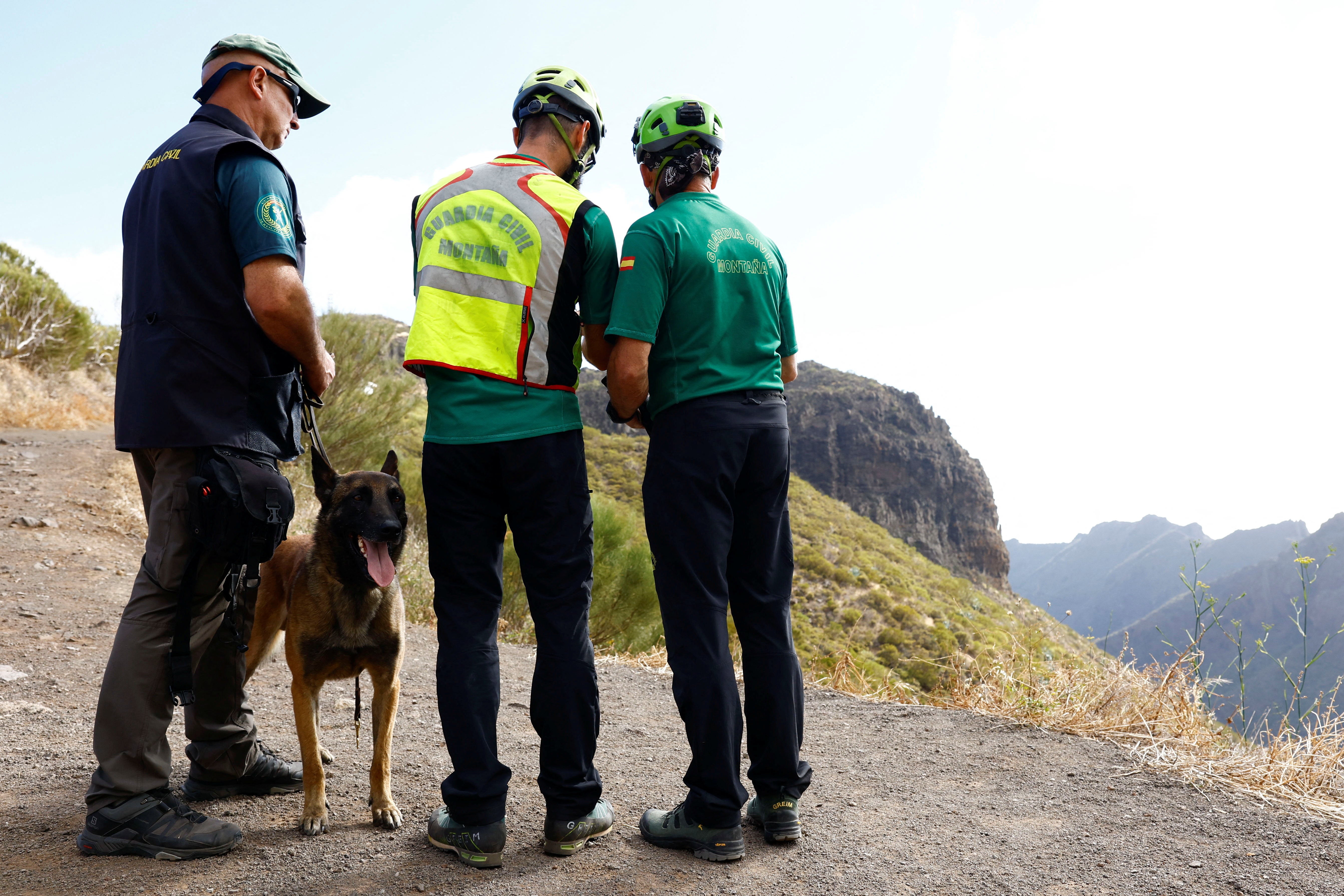 Police officers search for a young British man in the Masca ravine on the island of Tenerife in Spain on Wednesday