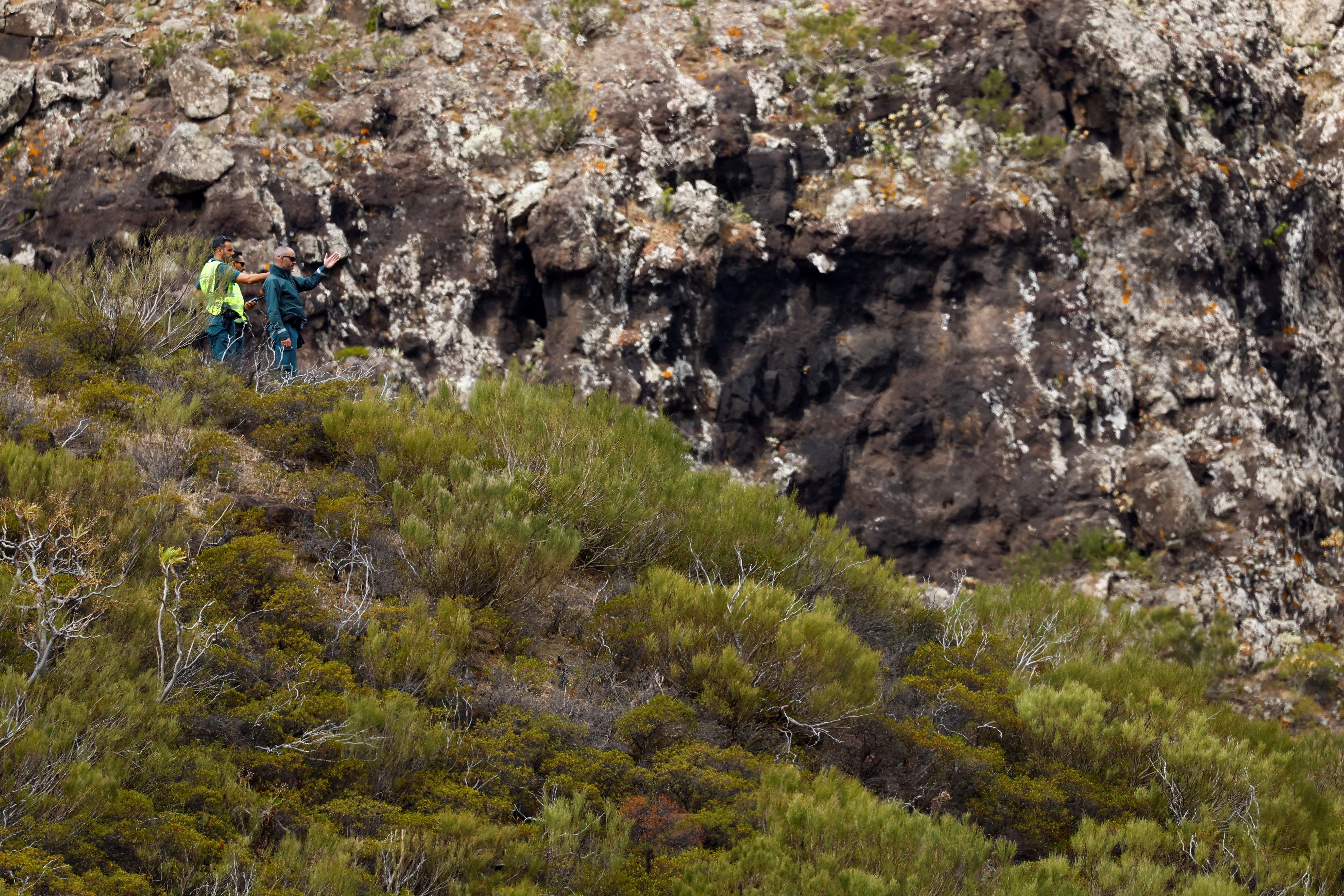 Police officers search for a missing British youth in the Masca ravine on the island of Tenerife in Spain on Thursday