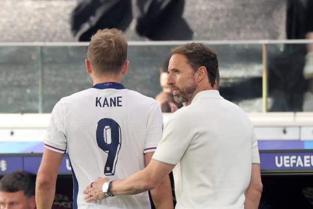 <p>Gareth Southgate (right) talks to Harry Kane after removing the England captain</p>