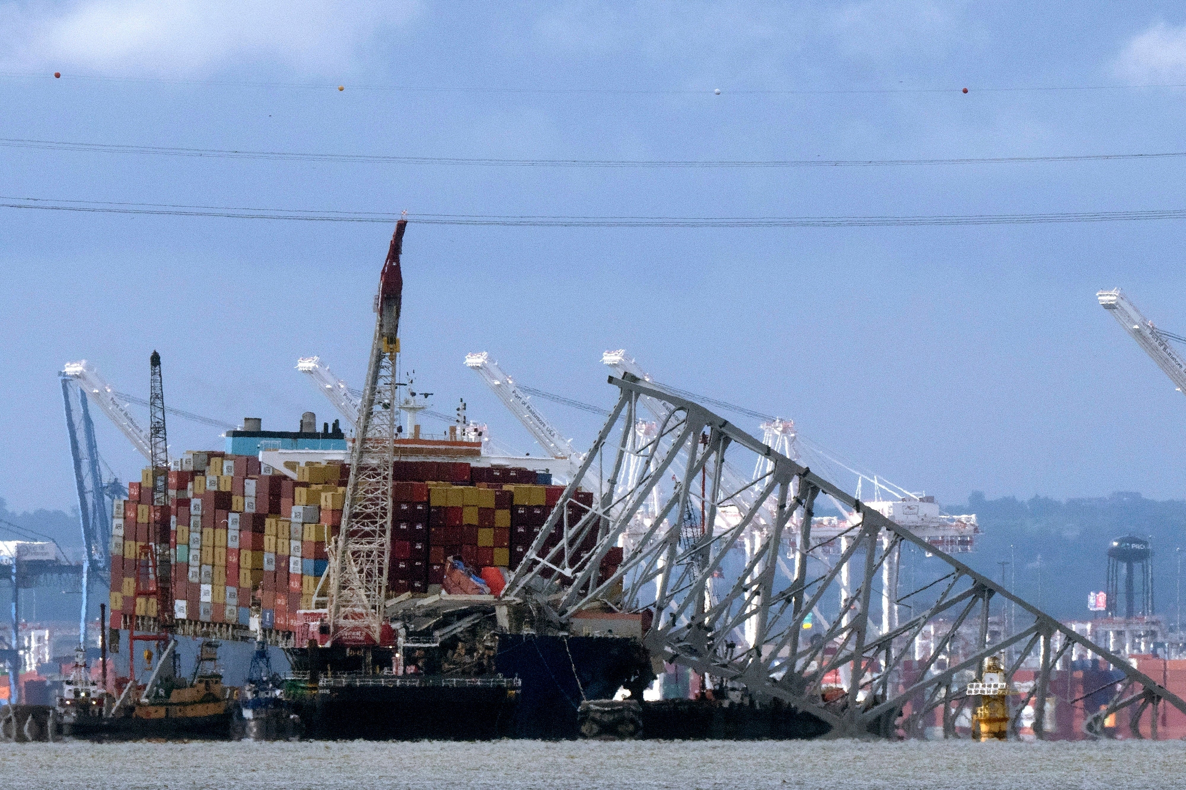 The collapsed Francis Scott Key Bridge rests on the container ship Dali, 12 May 2024, in Baltimore