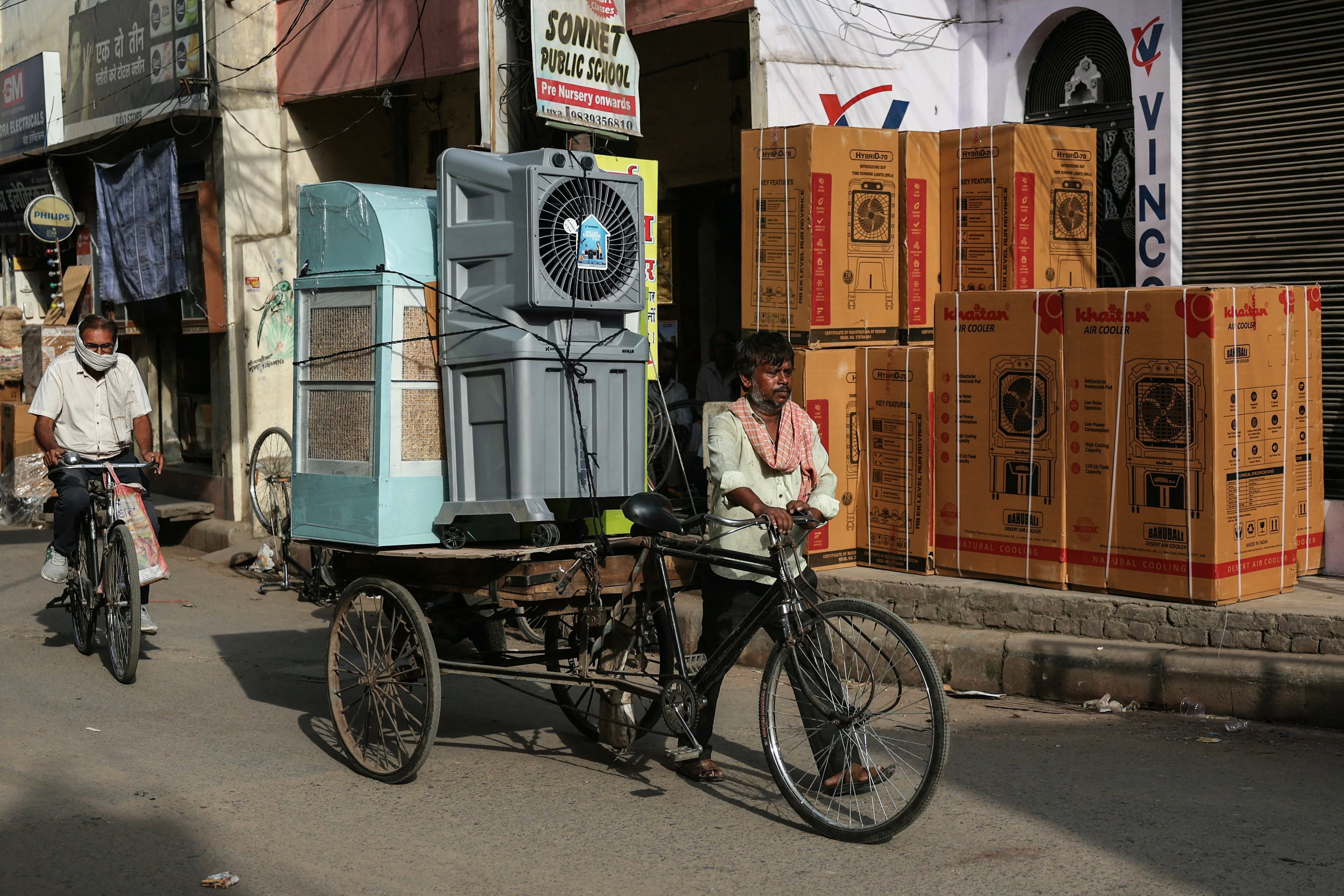 A man transports air coolers during a severe heatwave in the Indian city of Varanasi