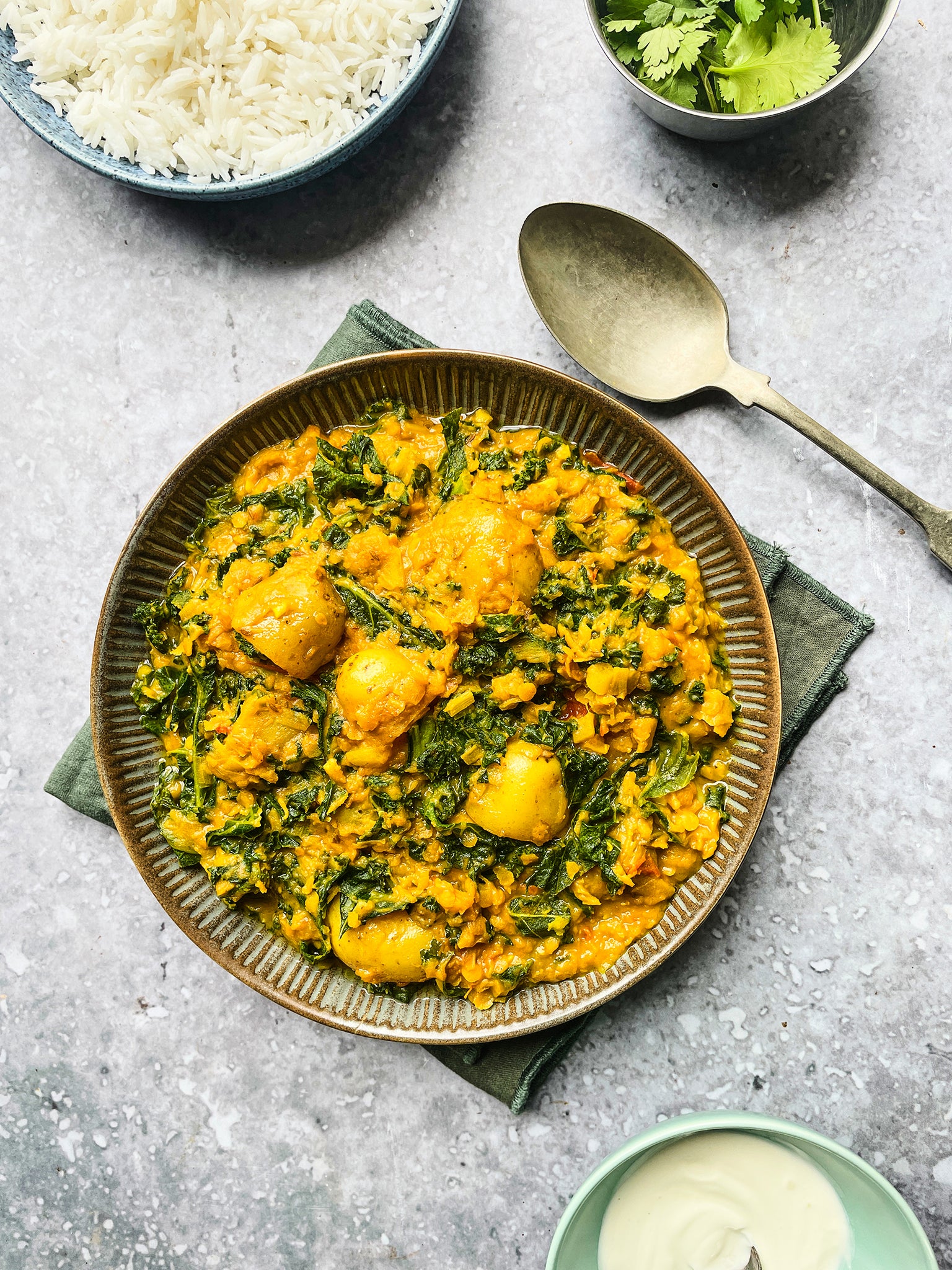 Creamy Potato and Kale Curry is perfect for cooking in large batches as it can be made ahead of time and frozen.