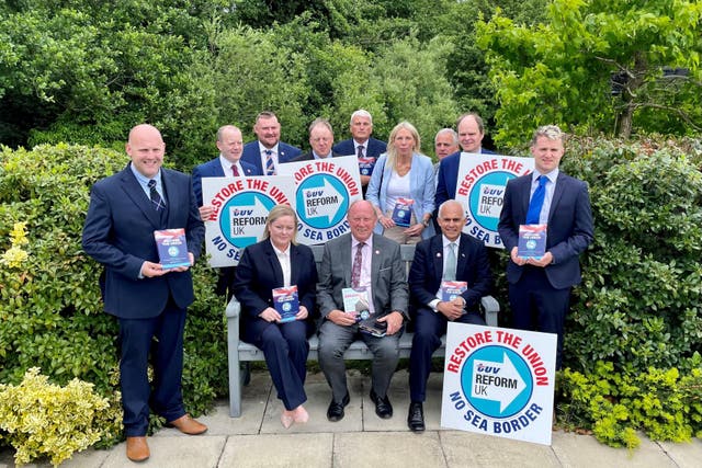 Reform UK deputy leader Ben Habib (on the bench, right) and TUV leader Jim Allister (on the bench centre) with parliamentary election candidates at the TUV manifesto launch (David Young/PA)