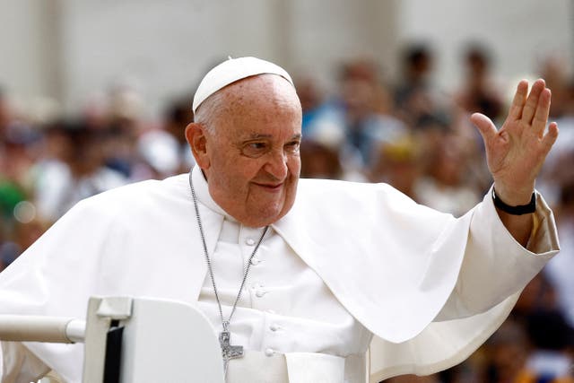 <p>Pope Francis greets people as he arrives for the weekly general audience at Saint Peter's Square at the Vatican</p>