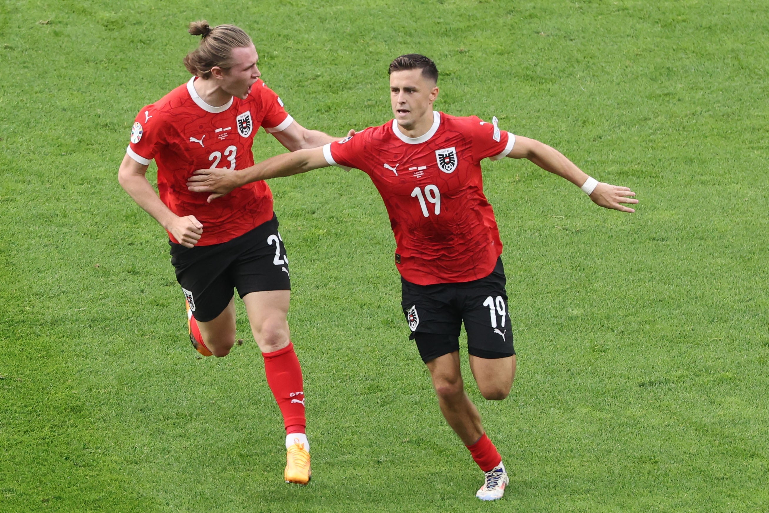 Christoph Baumgartner, right, celebrates after scoring the second goal for Austria