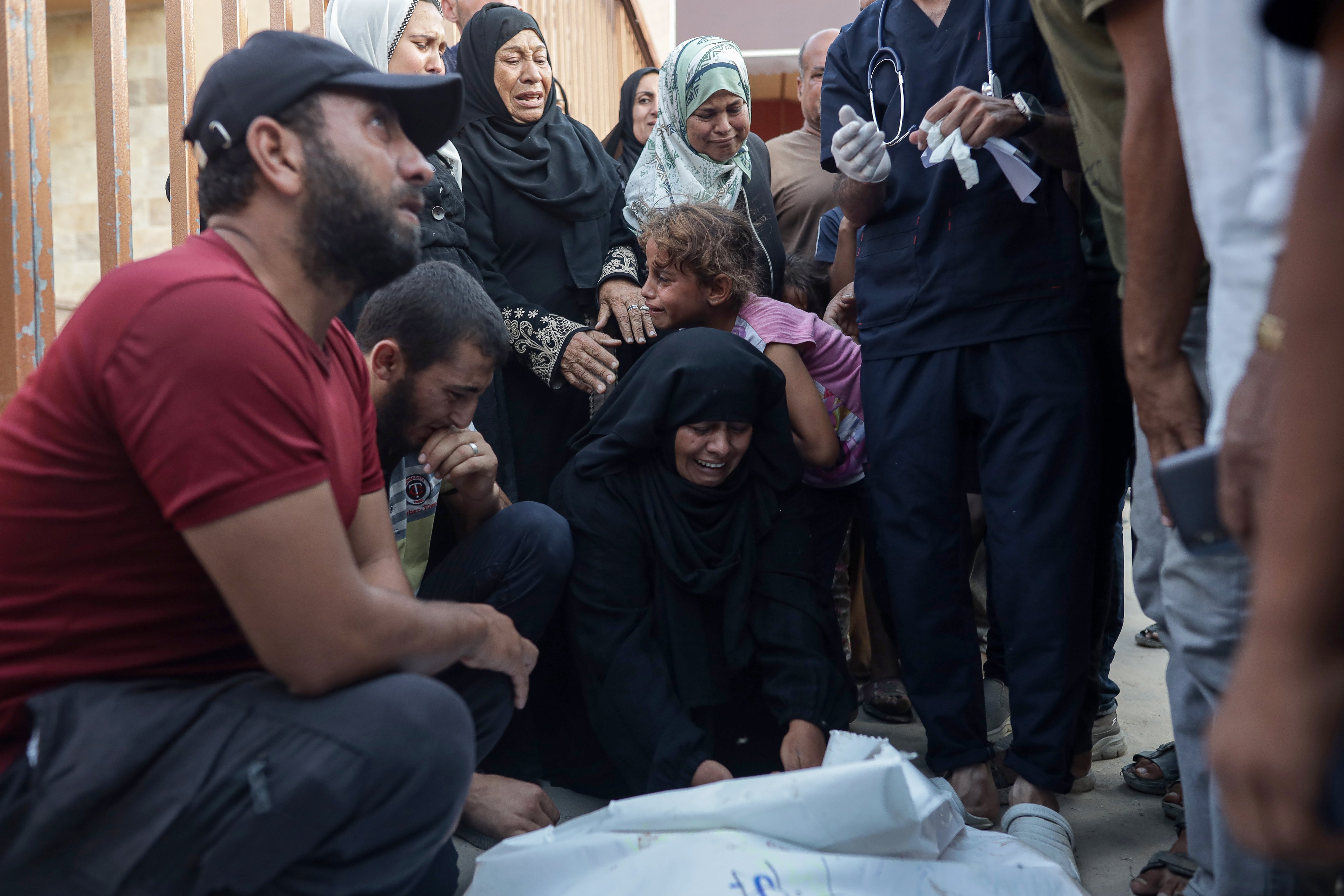 Palestinians mourn their relatives killed in an Israeli strike in Mawasi