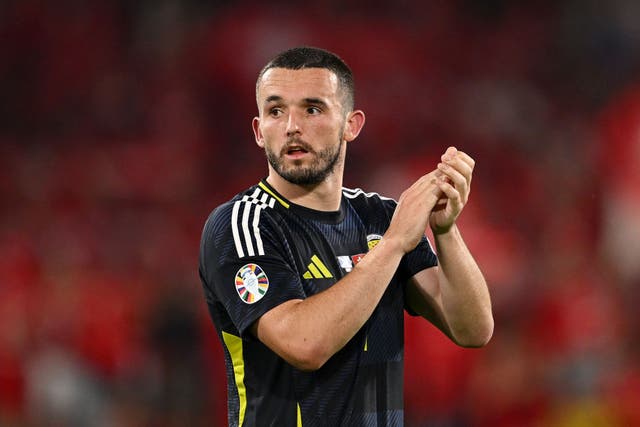 <p>John McGinn applauds the Tartan Army after he is brought off in the 1-1 draw against Switzerland </p>