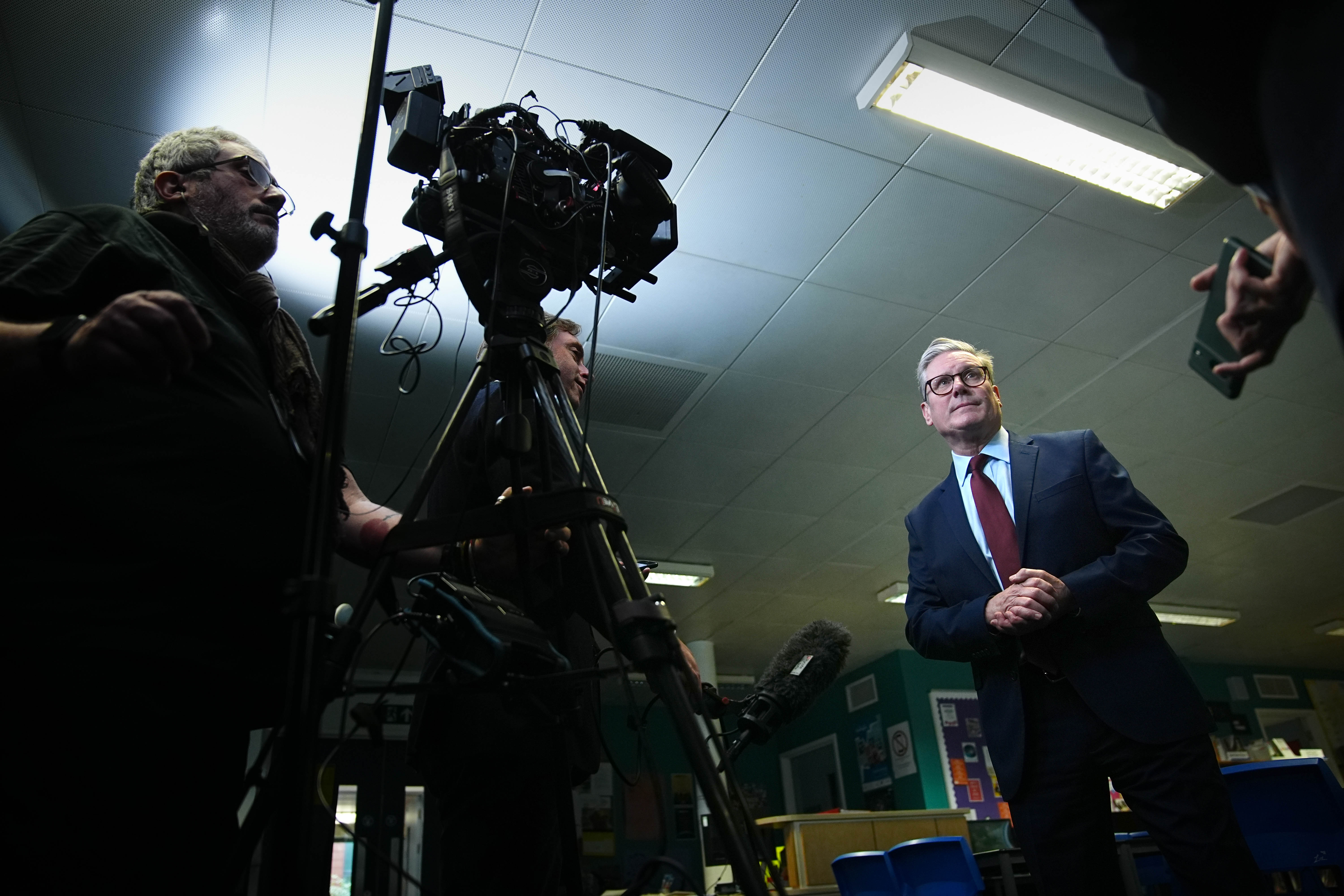 Labour Party leader Sir Keir Starmer (right) speaking to the media at a school in Vauxhall, London, while on the general election campaign trail on 22 June