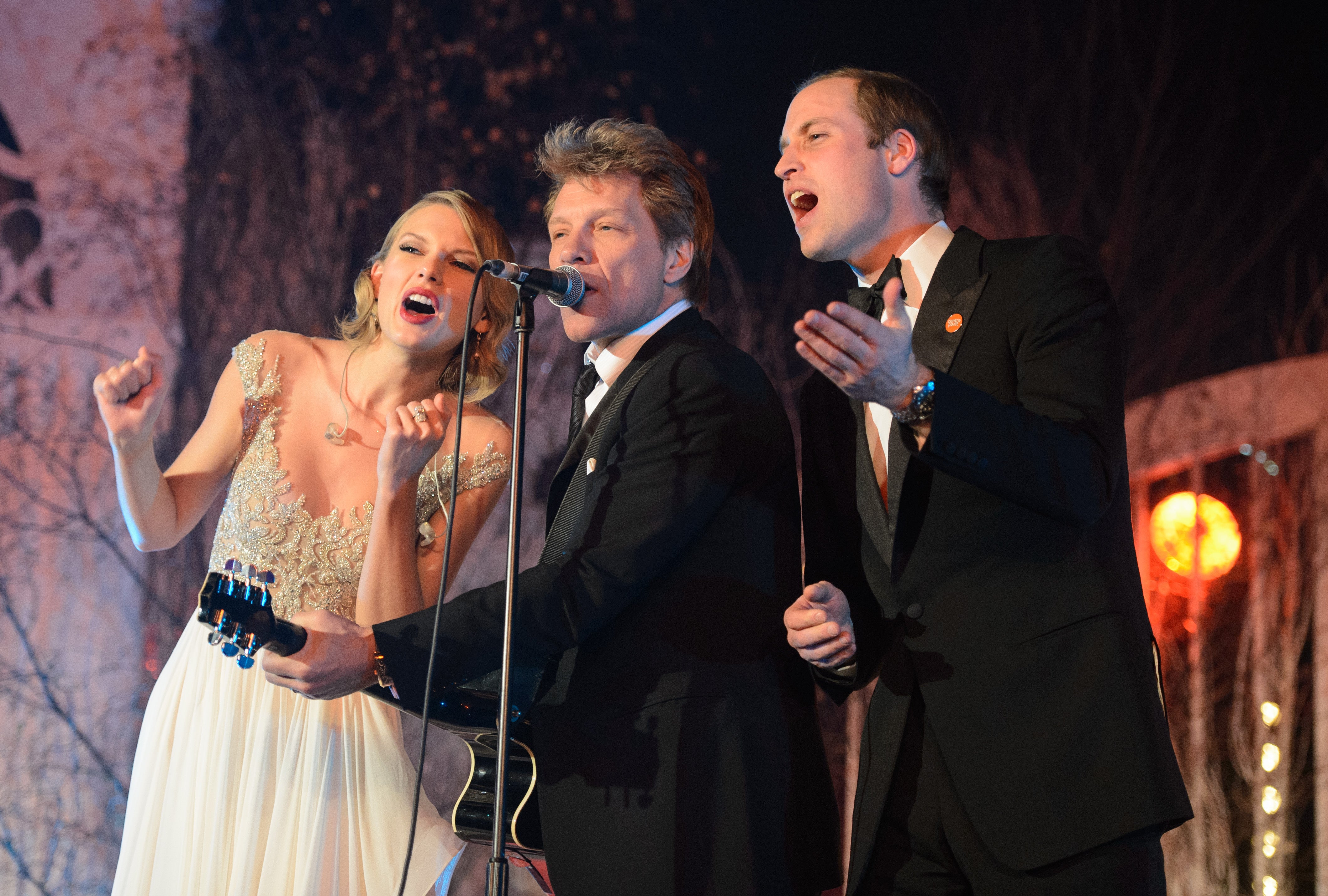 Taylor Swift, Jon Bon Jovi and Prince William sing on stage at the Centrepoint Gala Dinner at Kensington Palace in November 2013