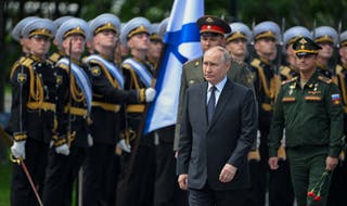 Russian President Vladimir Putin (C) attends a wreath-laying ceremony at the Tomb of the Unknown Soldier in Alexandrovsky Park near the Kremlin wall in Moscow