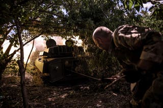 A serviceman of the 24th Mechanized brigade named after King Danylo of the Ukrainian Armed Forces fires a 2S1 Gvozdika self-propelled howitzer towards Russian troops in a front line near the town of Chasiv Yar in Donetsk region