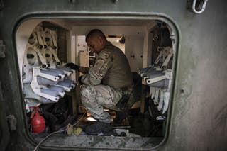 A serviceman prepares to fire a “Gvozdika” 120mm Soviet-made howitzer towards Russian positions at outskirts of Chasiv Yar, Donetsk region, Ukraine