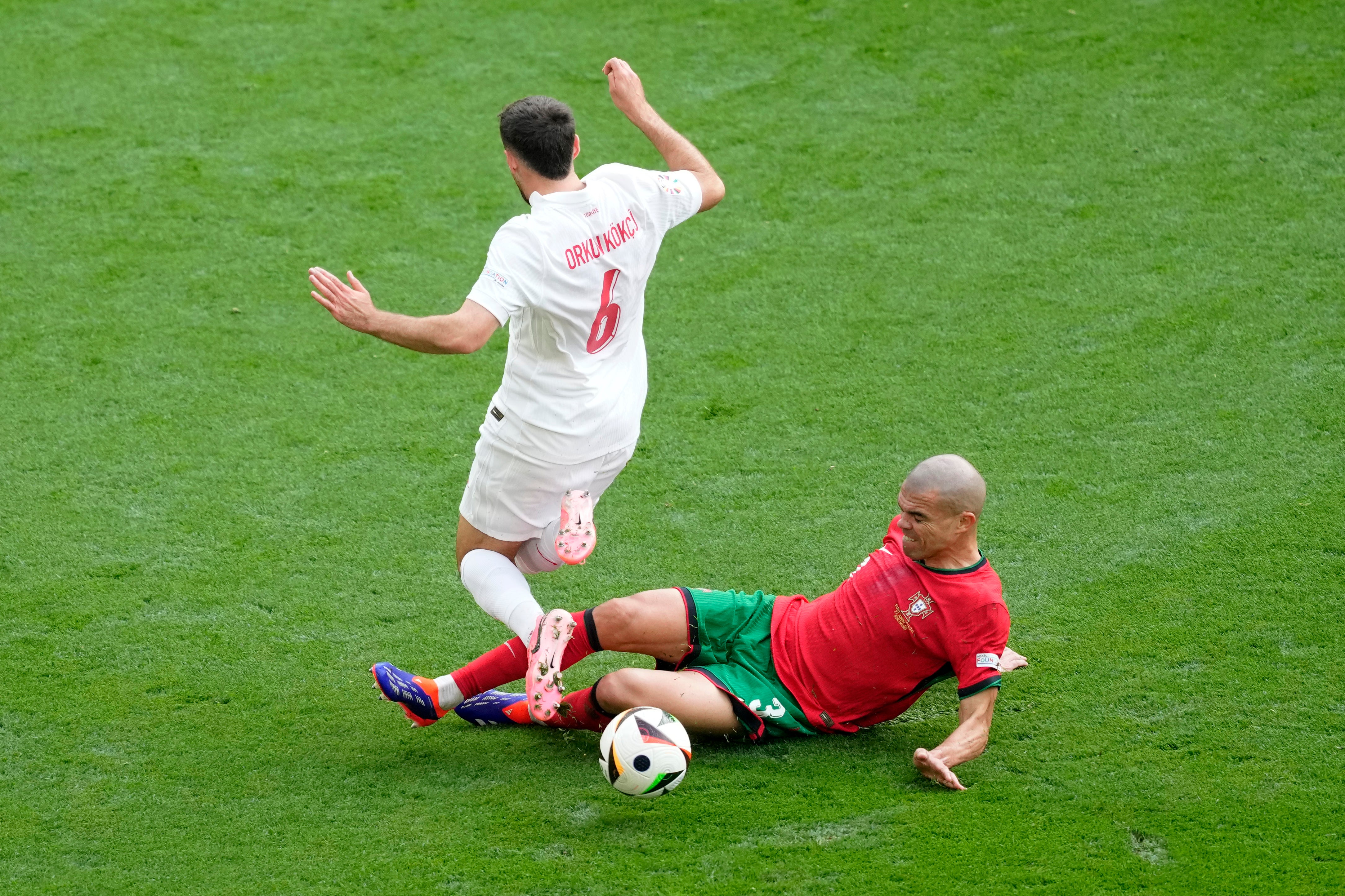 Pepe’s sliding tackle dispossesses Orkun Kokcu.