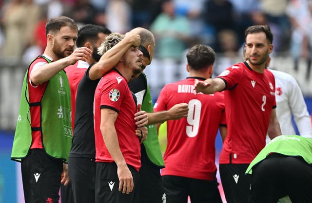 <p> Saba Lobjanidze of Georgia is consoled by teammates</p>