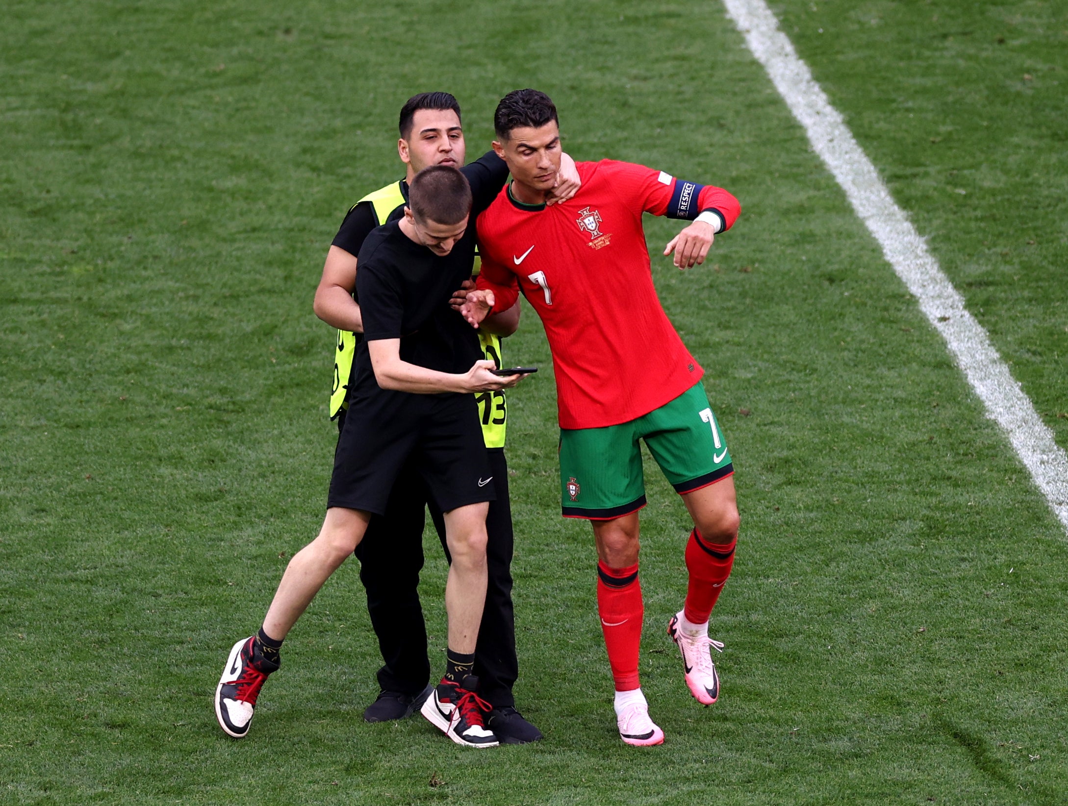 One fan grabs Ronaldo by the neck as he tries to take a selfie with the star forward