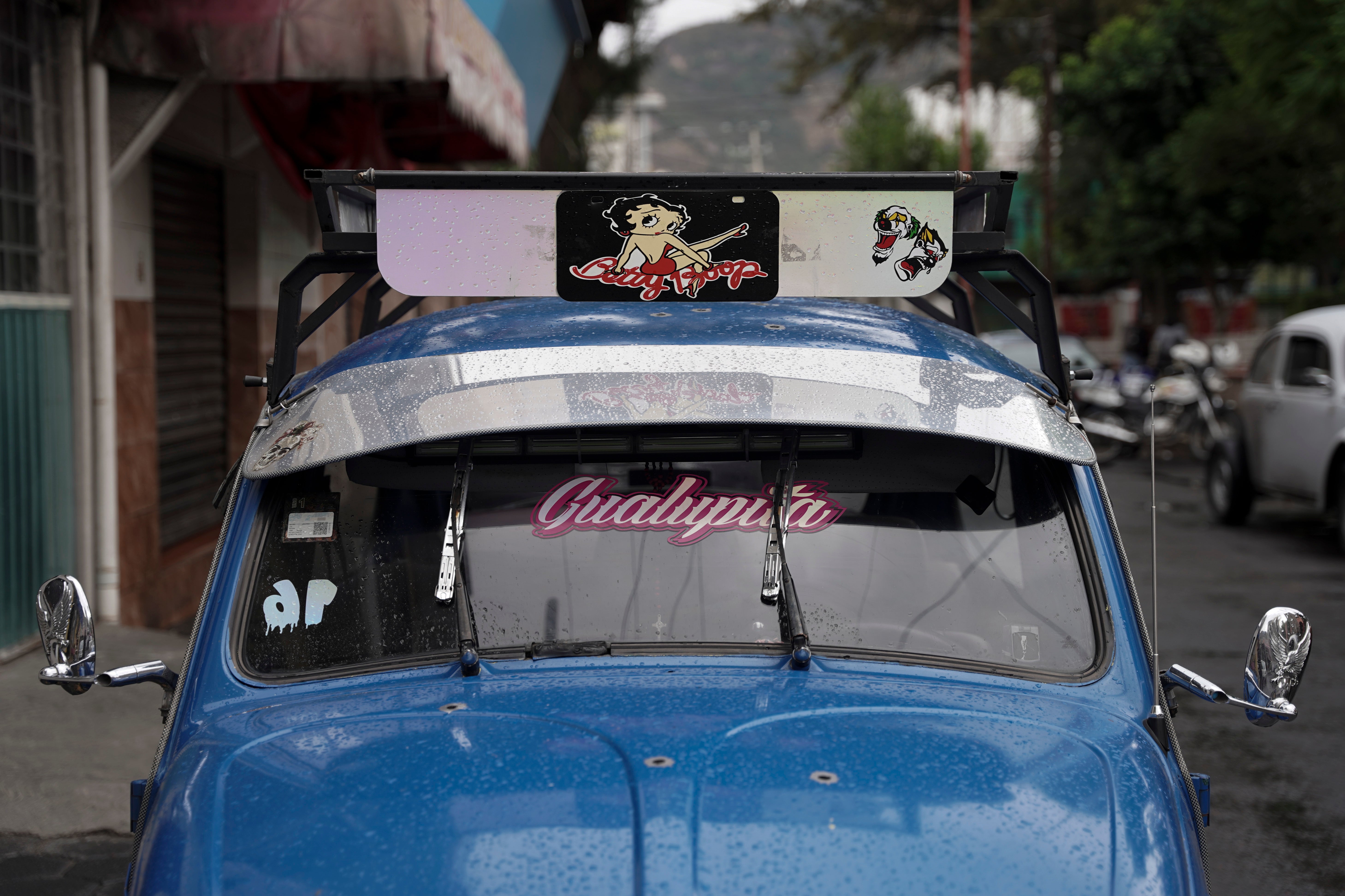 The bright blue Volkswagen Beetle owned by taxi driver Claudio Garcia that he named “Gualupita” after his wife