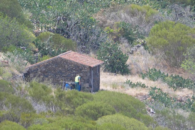 <p>A member of a search and rescue team searches near the last known location of Jay Slater, close to the village of Masca, Tenerife (James Manning/PA)</p>