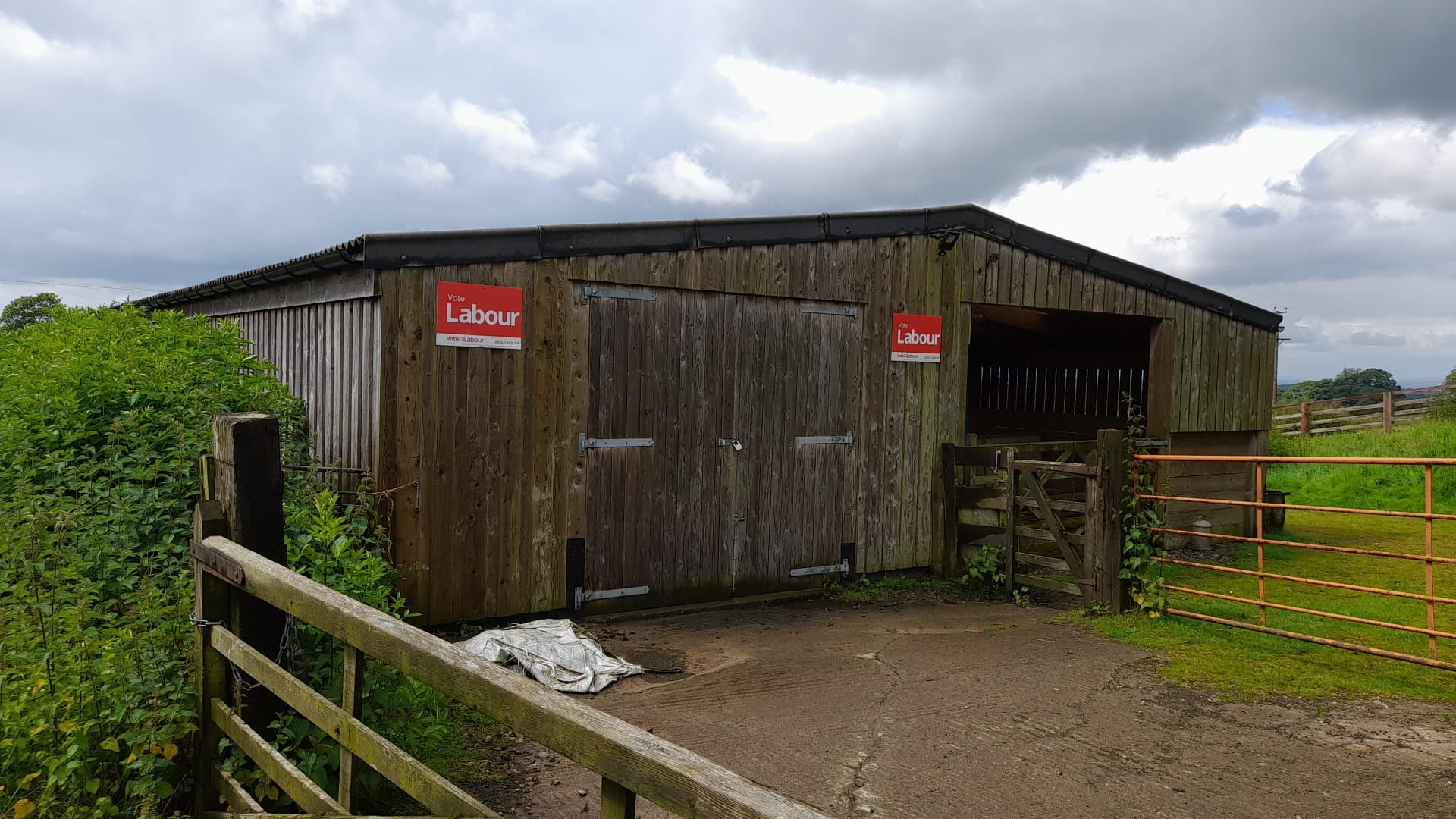 A local farmer puts Labour posters up on his barn to support Wilson against Sunak