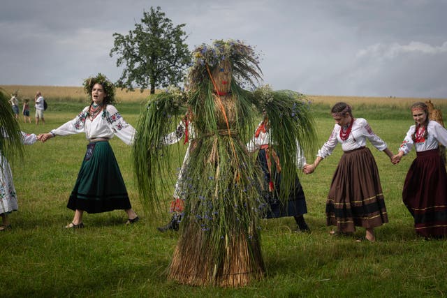 <p>Ukrainian young women dressed in traditional clothing dance in circle at a traditional Midsummer Night celebration </p>