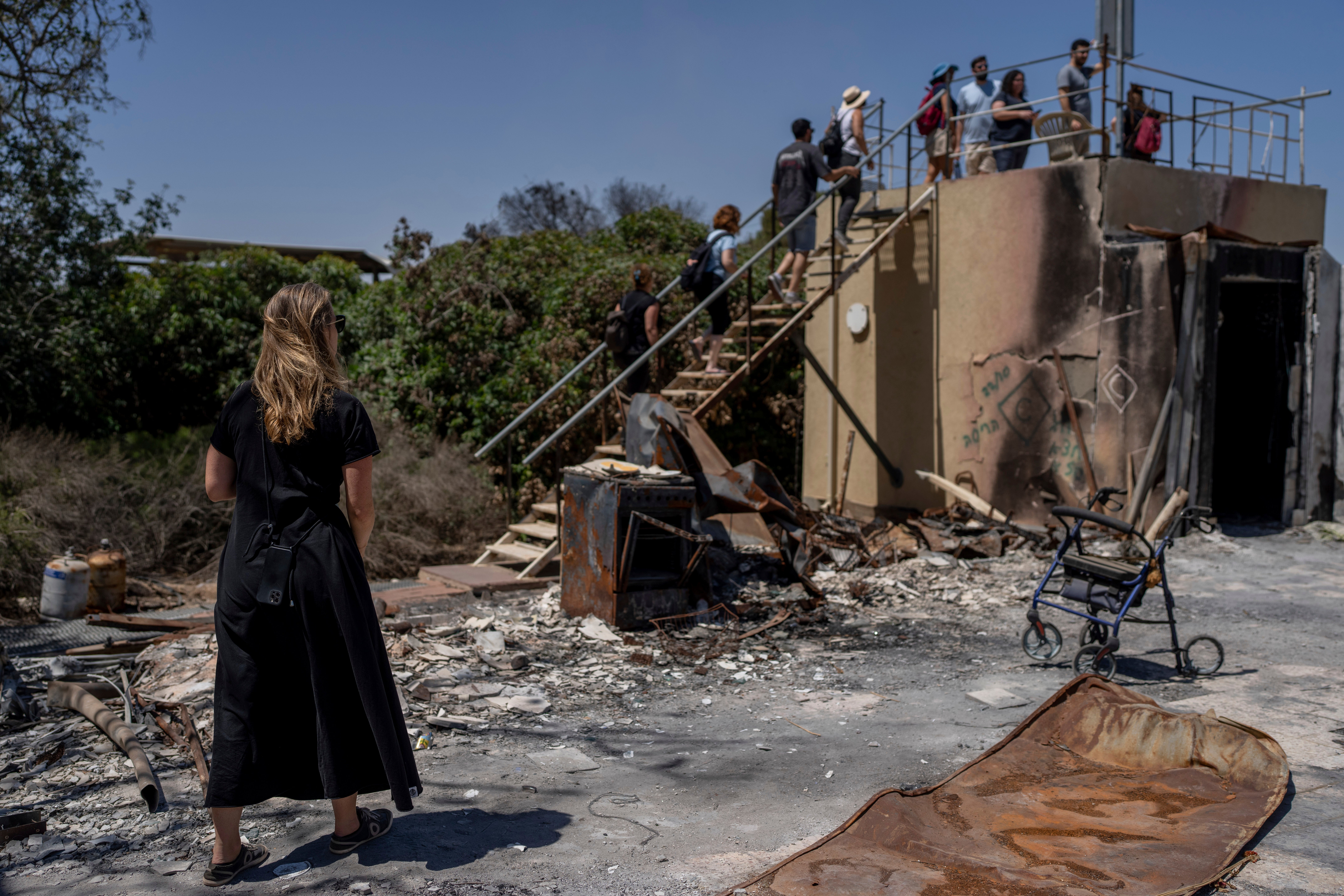 A group of Israelis on an educational tour visit a house that was torched by Hamas militants on the October 7 attack